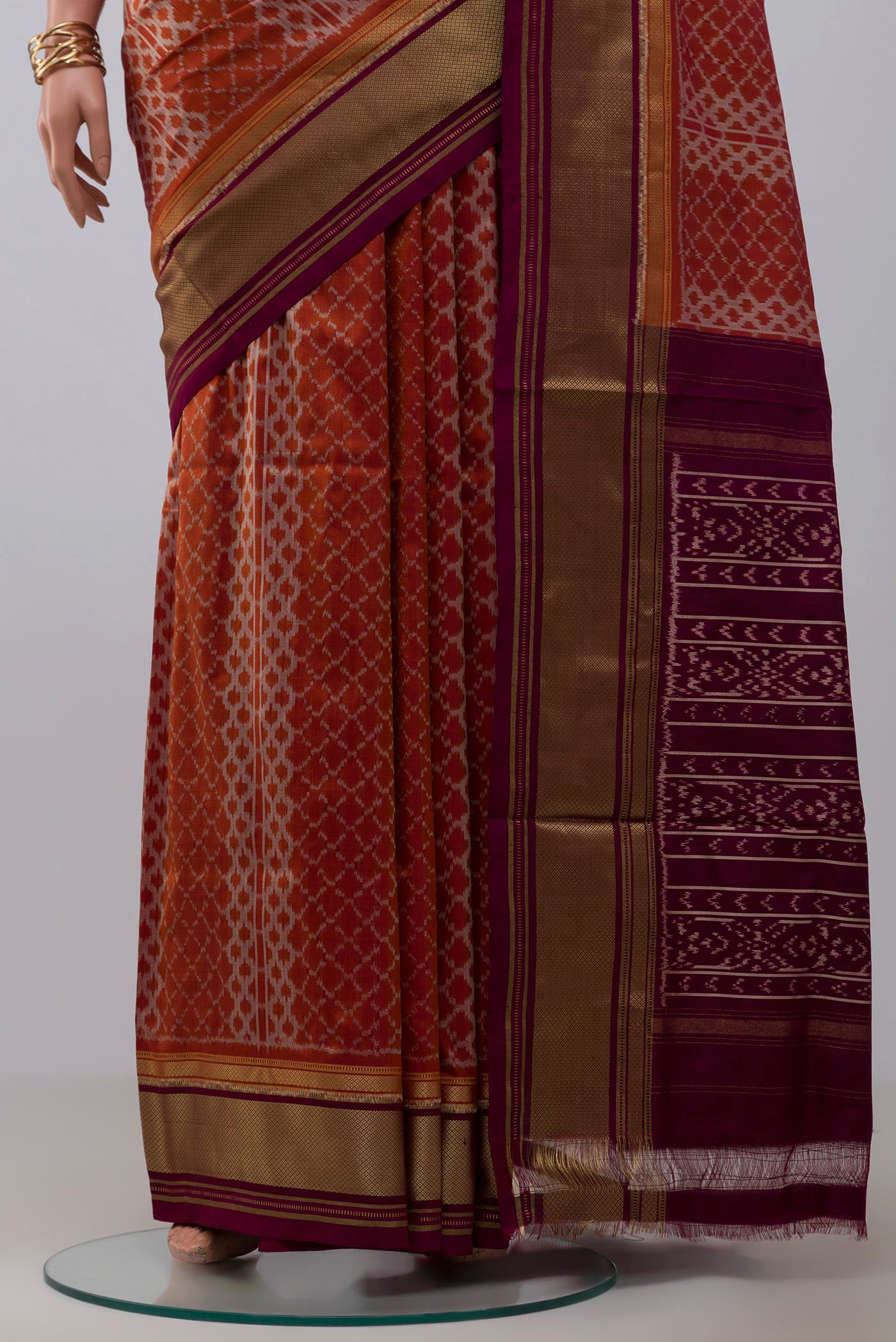 Pleats and pallu of Rust Pochampally Silk Saree with Ikat design on the body and Zari Border. 