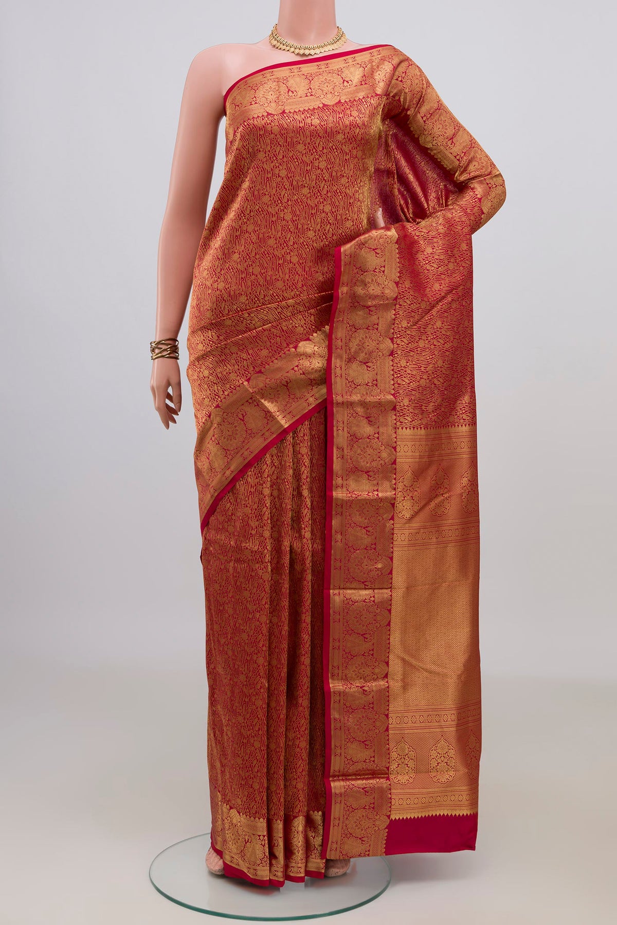 Pure Silk Red Kanjivaram Saree with Zari Brocade on the body and Zari Border.  displayed on a mannequin
