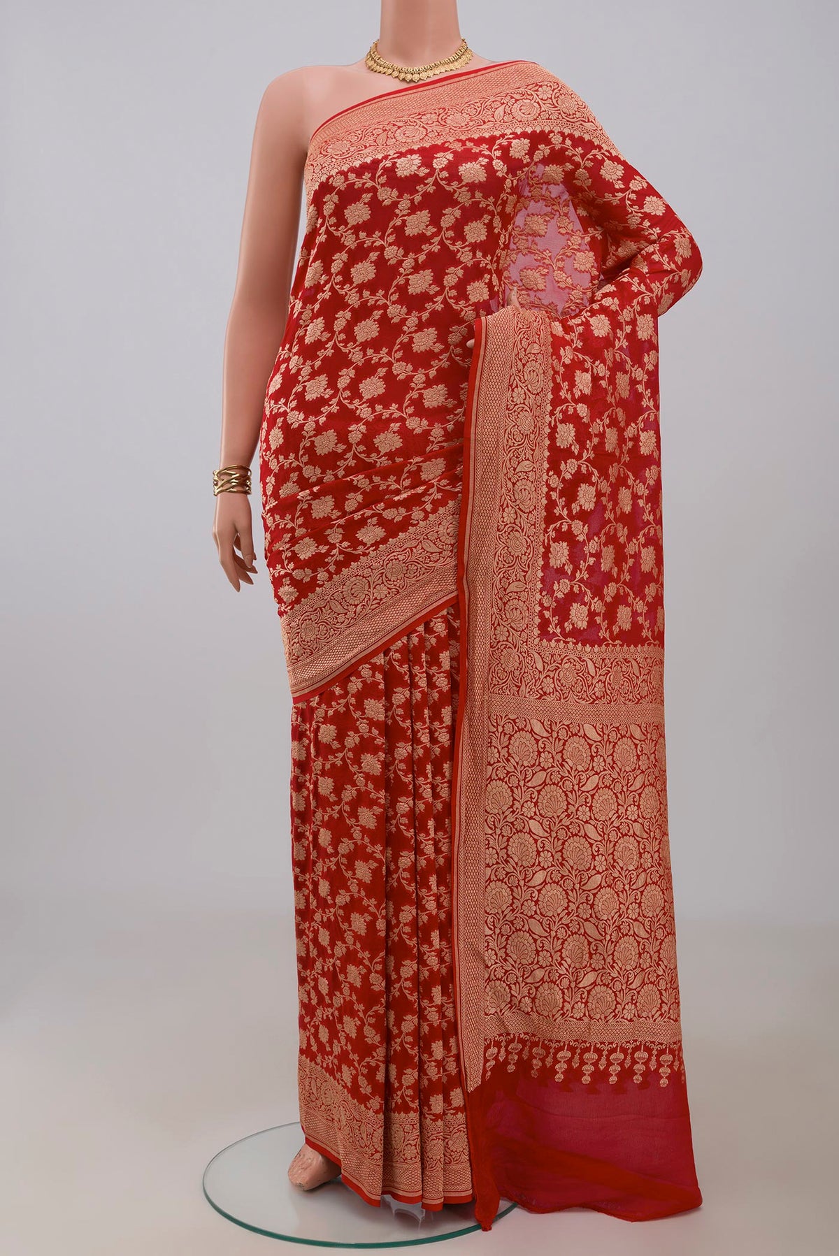 Red Georgette Saree with Fancy on the body and Fancy Border.  displayed on a mannequin