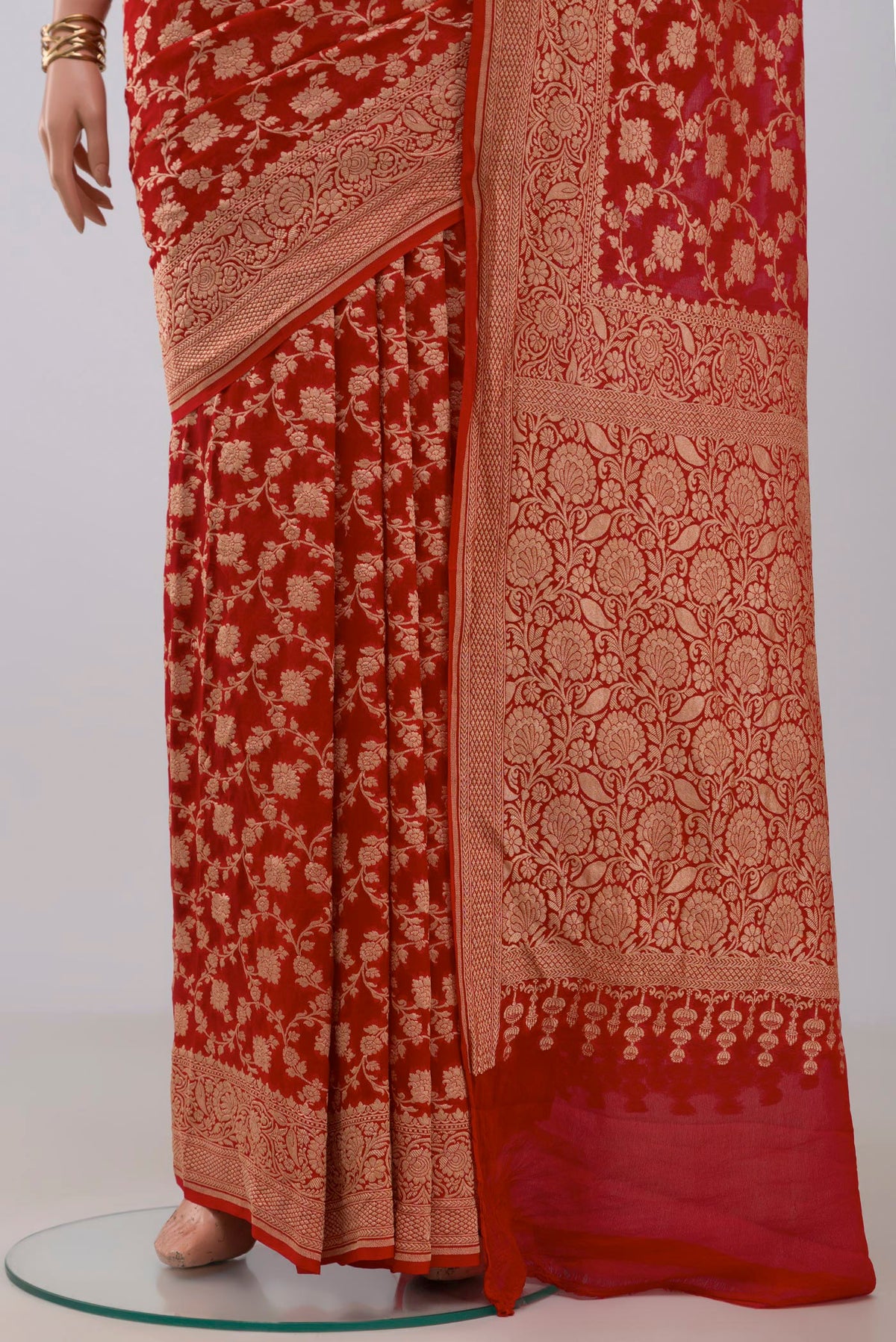 Pleats and pallu of Red Georgette Saree with Fancy on the body and Fancy Border. 