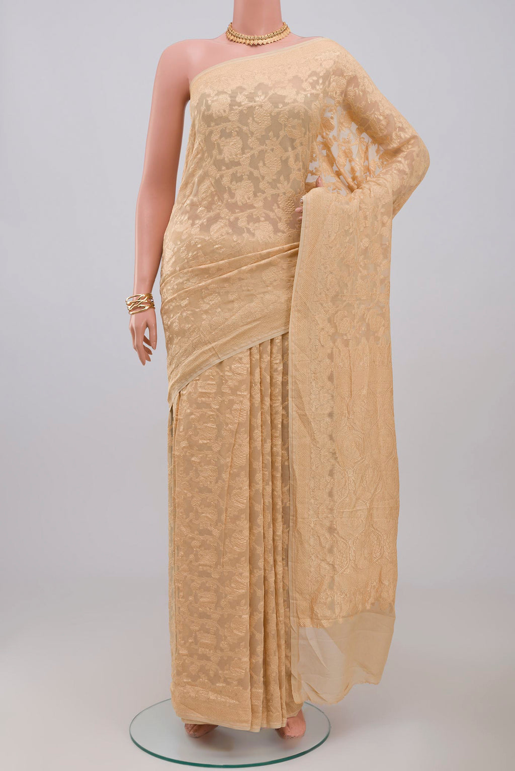 Cream Georgette Saree with Fancy on the body and Zari Border.  displayed on a mannequin