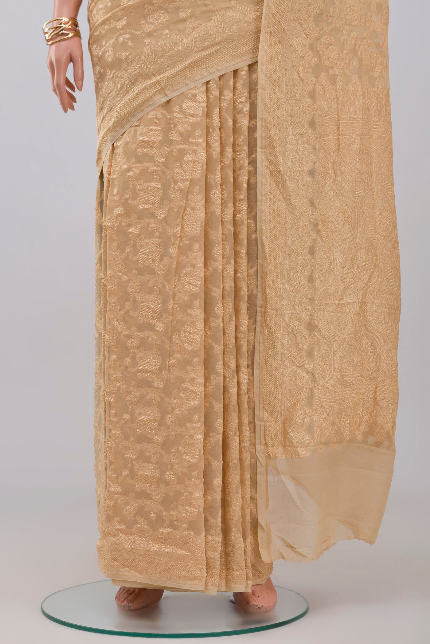 Pleats and pallu of Cream Georgette Saree with Fancy on the body and Zari Border. 