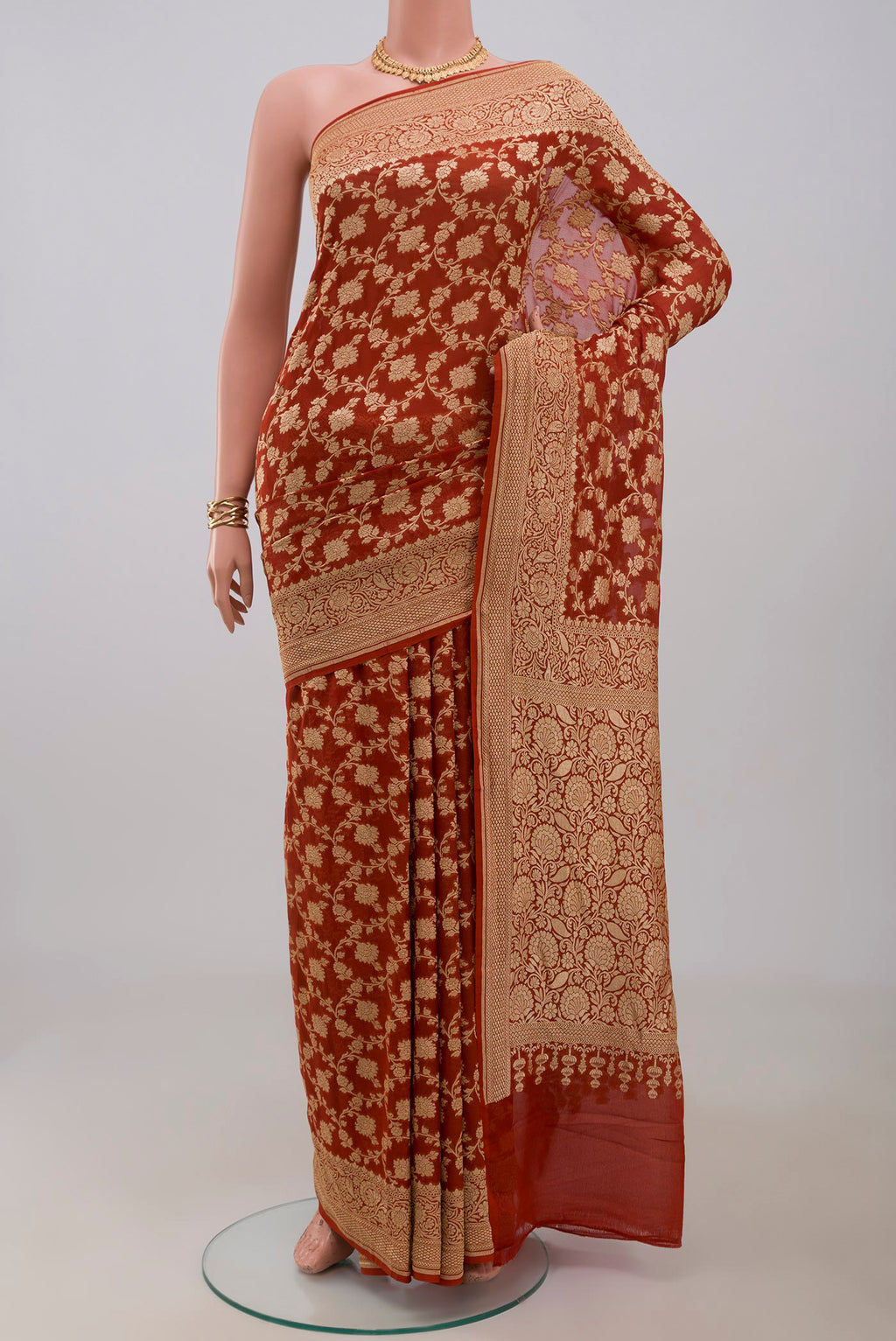 Rust Georgette Saree with Fancy on the body and Fancy Border.  displayed on a mannequin