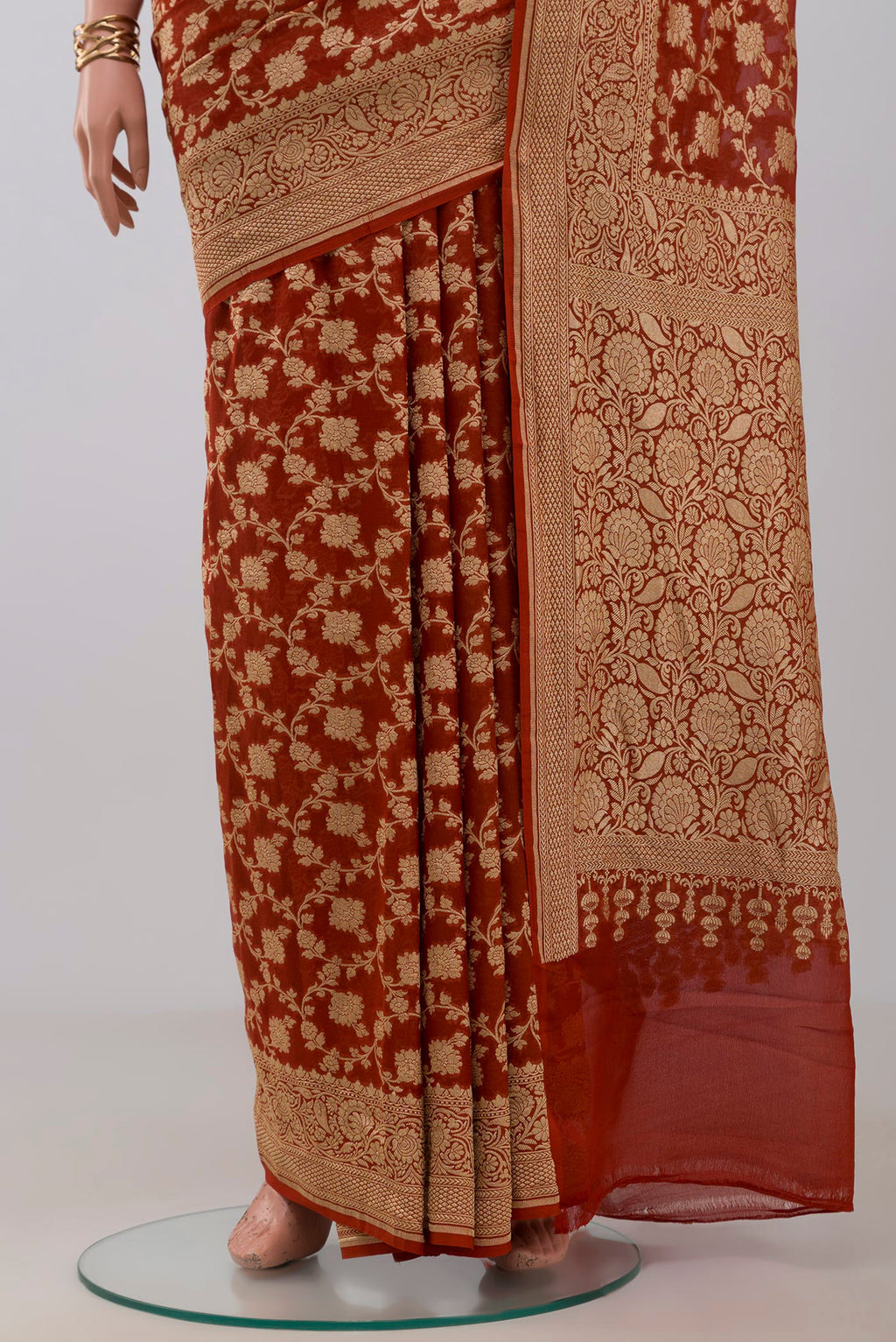 Pleats and pallu of Rust Georgette Saree with Fancy on the body and Fancy Border. 