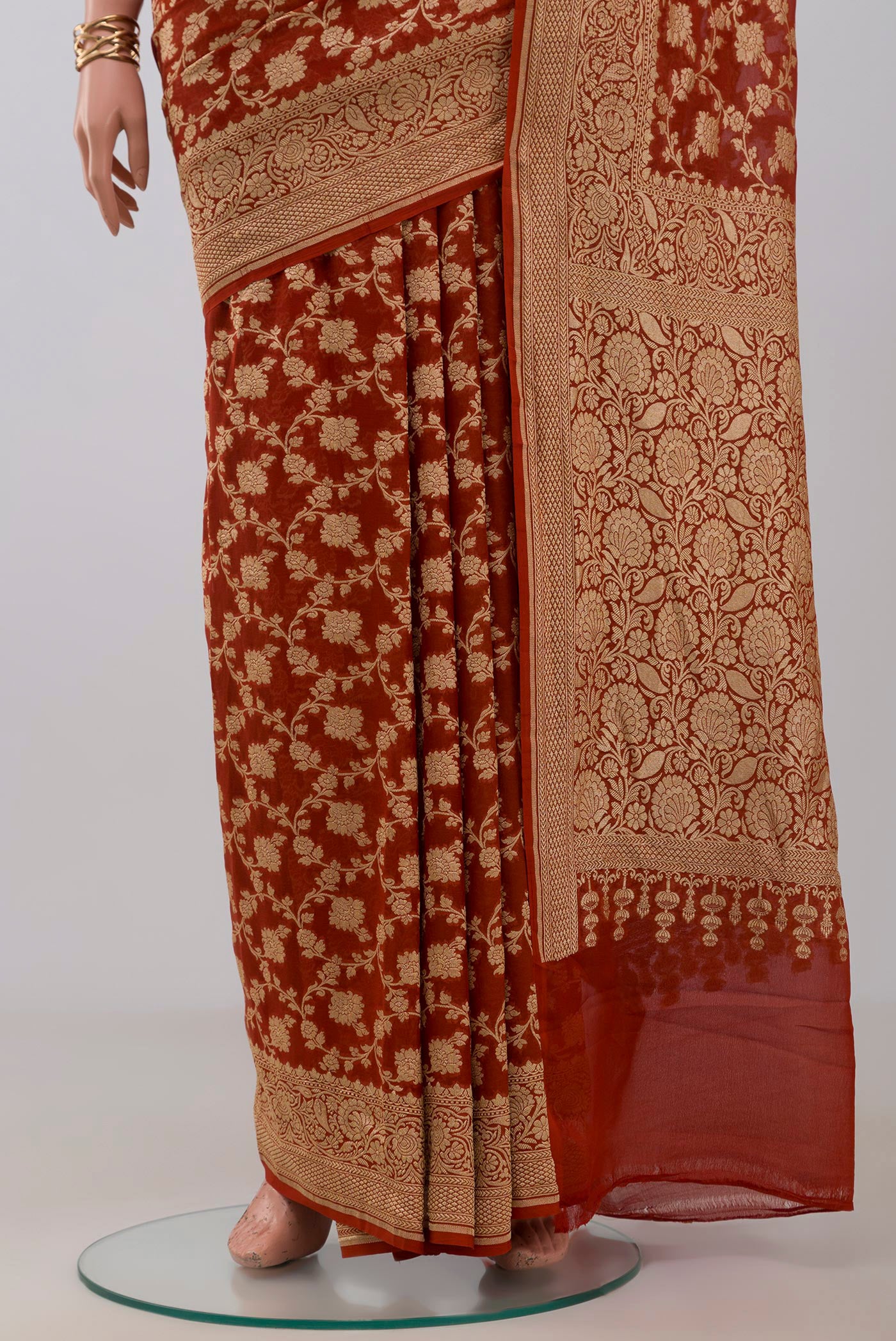 Pleats and pallu of Rust Georgette Saree with Fancy on the body and Fancy Border. 