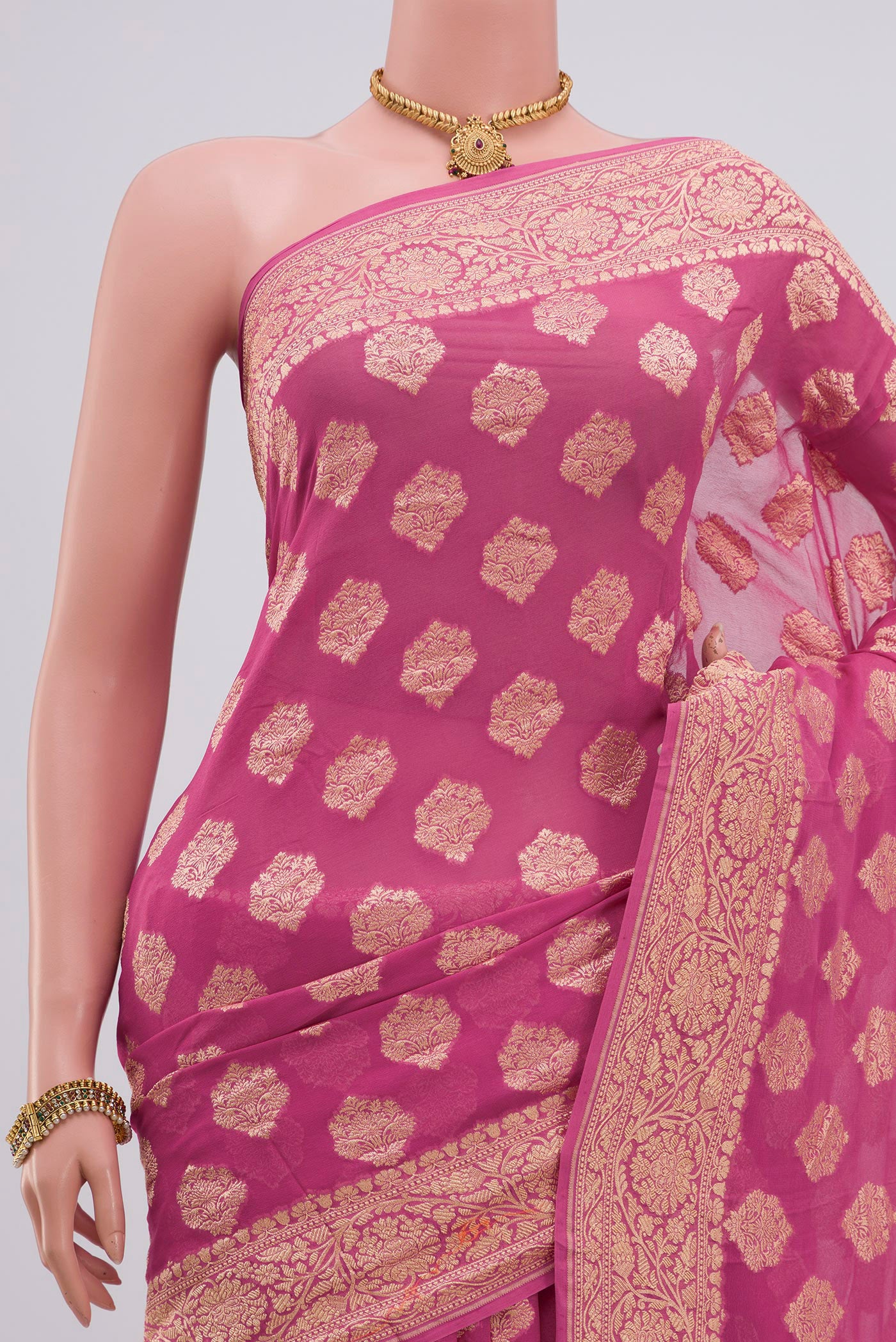 Border image of Pink Georgette Saree with Zari Butta on the body and Zari Border. 