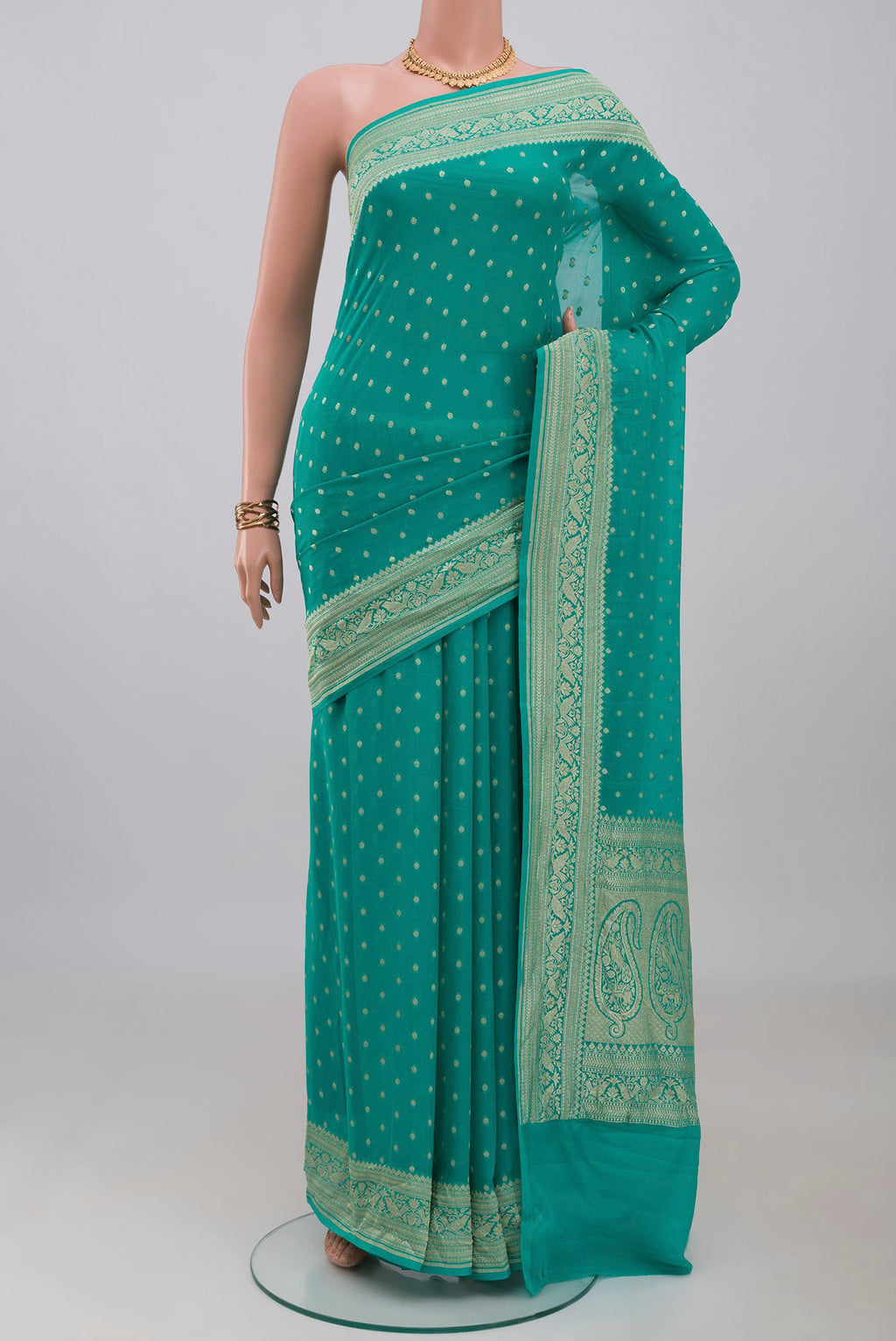 Turquoise Banarasi Georgette Saree with Zari Butta on the body and Zari Border.  displayed on a mannequin