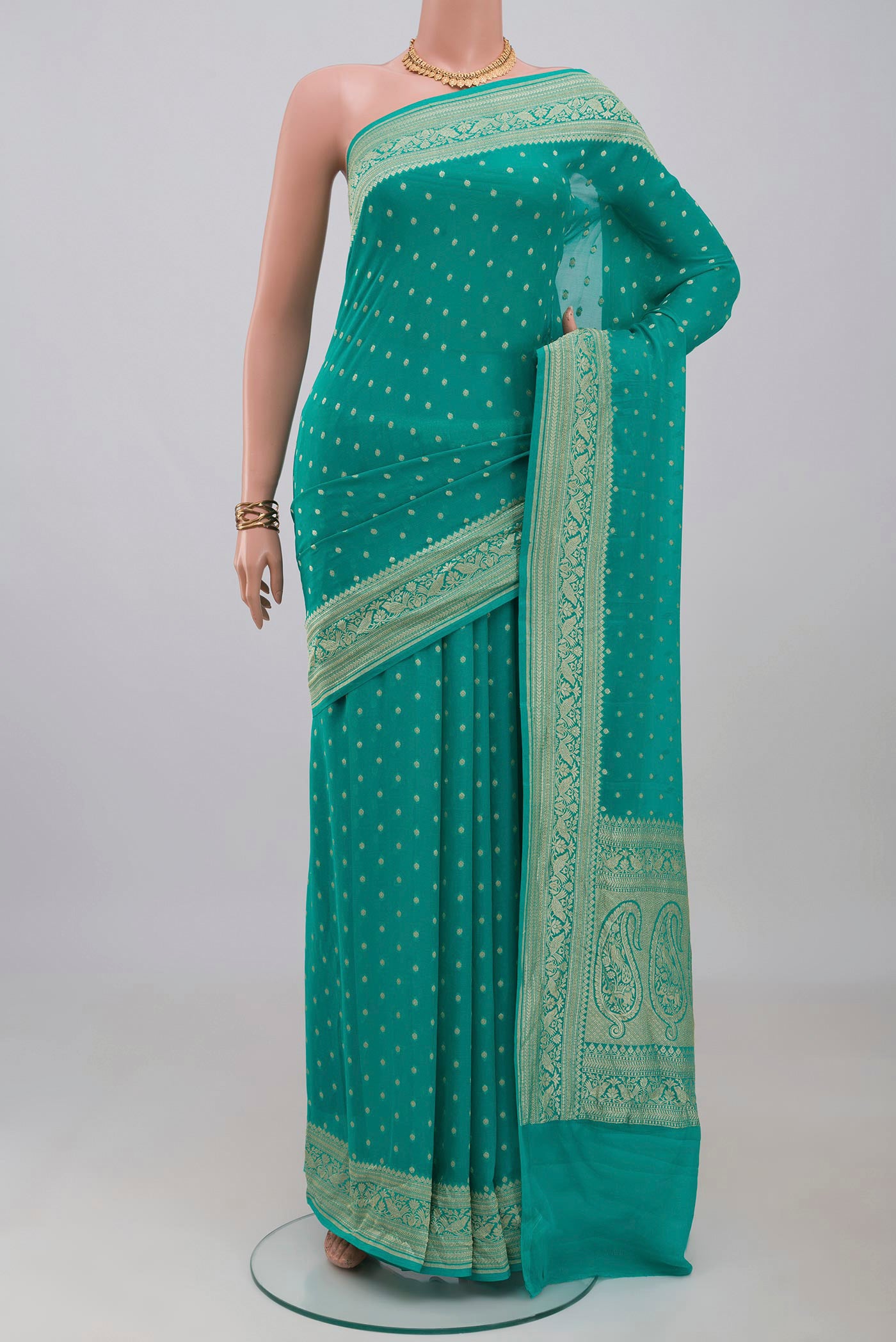 Turquoise Banarasi Georgette Saree with Zari Butta on the body and Zari Border.  displayed on a mannequin