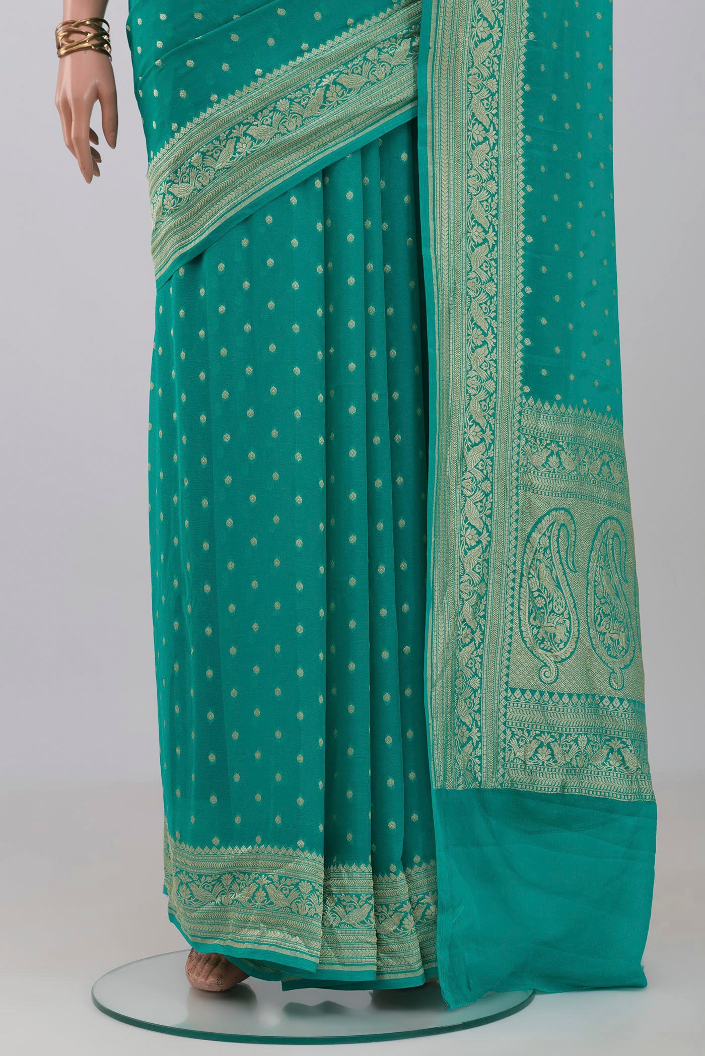 Pleats and pallu of Turquoise Banarasi Georgette Saree with Zari Butta on the body and Zari Border. 