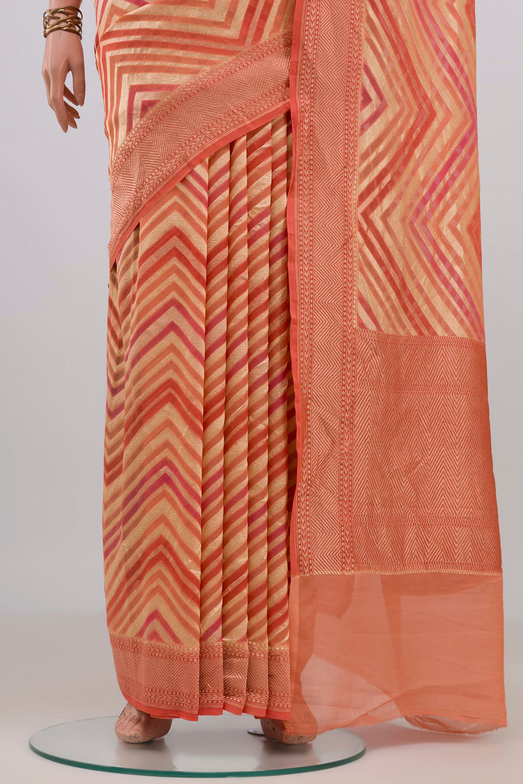 Pleats and pallu of Peach Banarasi Georgette Saree with Zig Zag design on the body and Zari Border. 