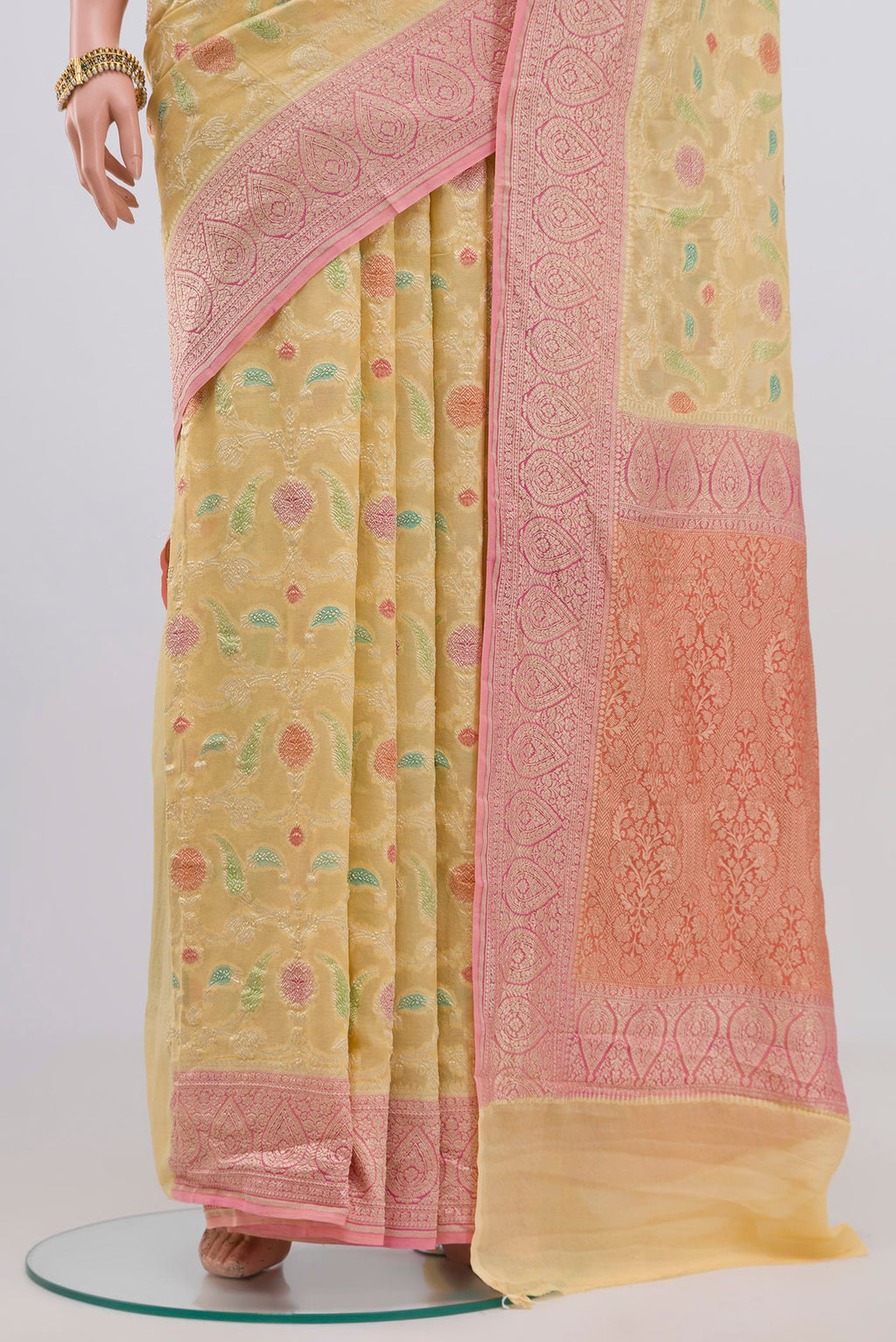 Pleats and pallu of Yellow Georgette Saree with Fancy on the body and Zari Border. 