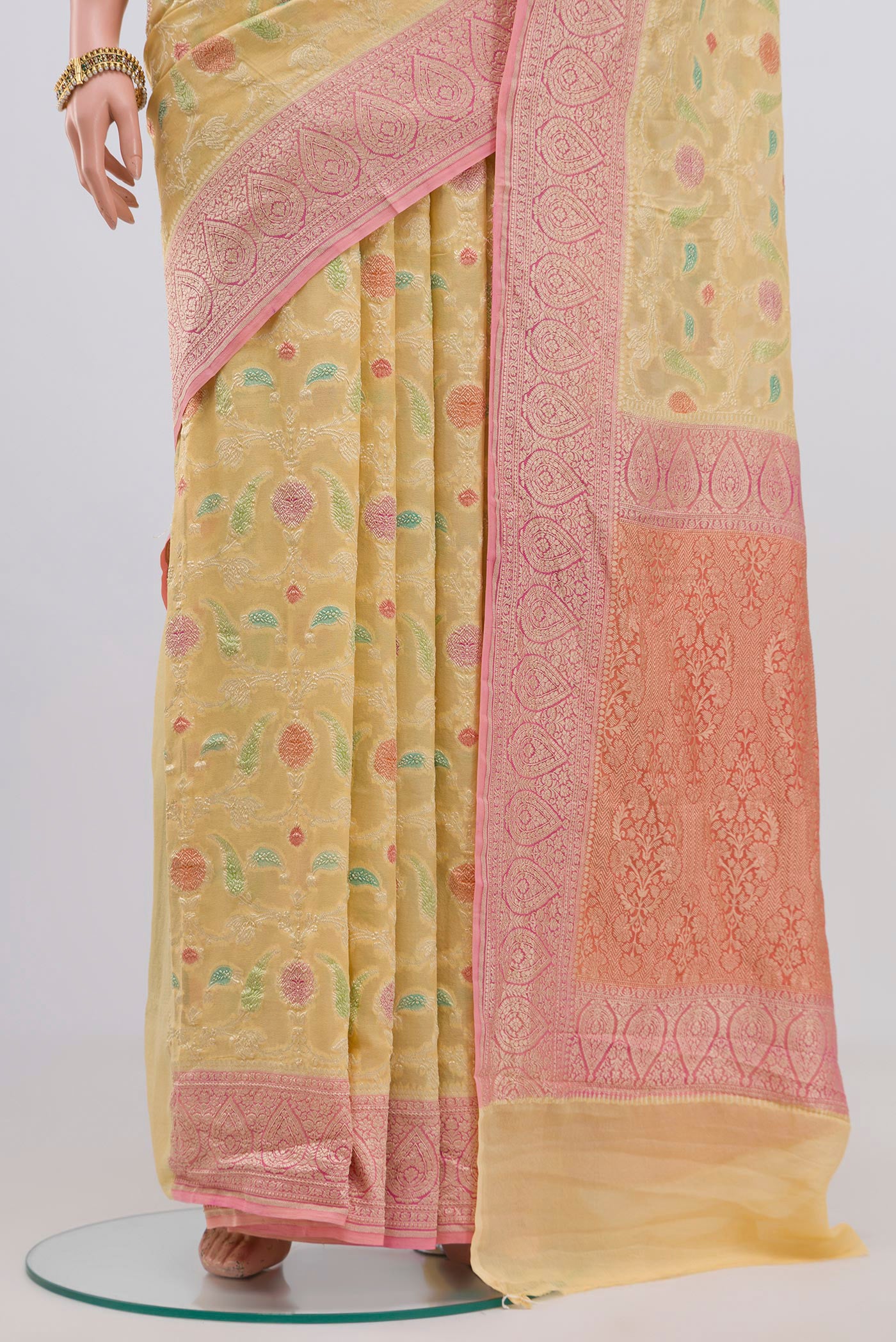 Pleats and pallu of Yellow Georgette Saree with Fancy on the body and Zari Border. 