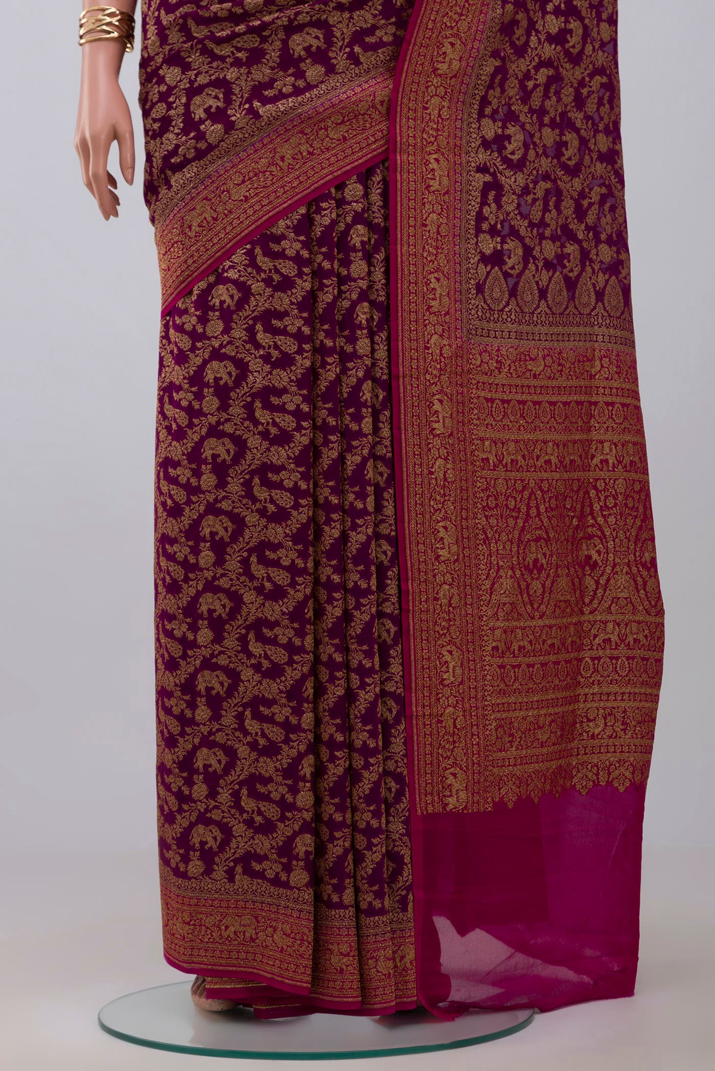 Pleats and pallu of Purple Banarasi Georgette Saree with Fancy on the body and Fancy Border. 