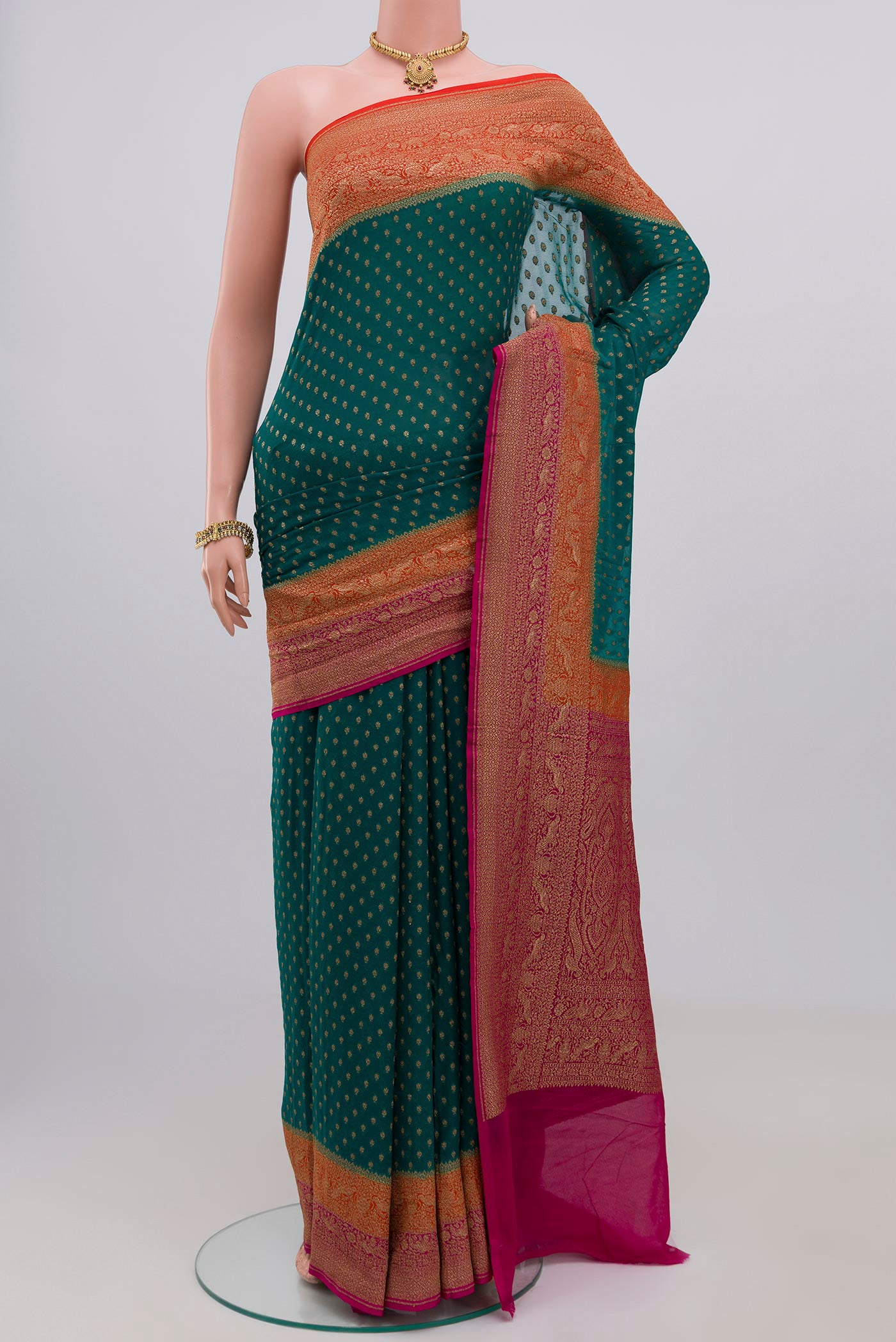 Green Georgette Saree with Zari Butta on the body and Zari Border.  displayed on a mannequin