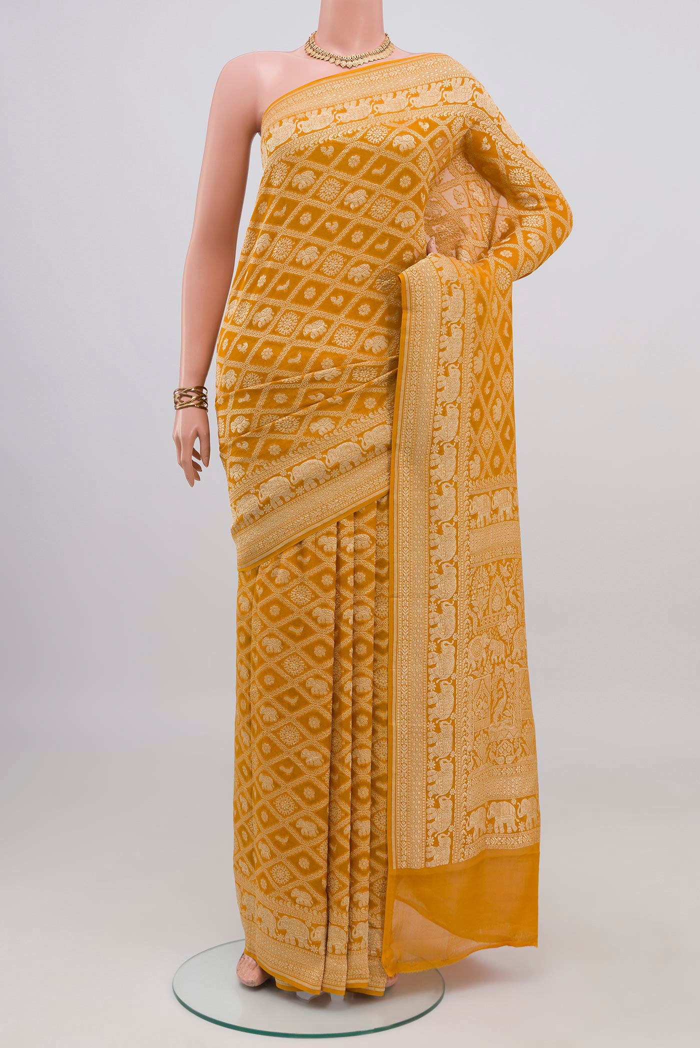 Yellow Banarasi Georgette Saree with Zari Brocade on the body and Zari Border.  displayed on a mannequin