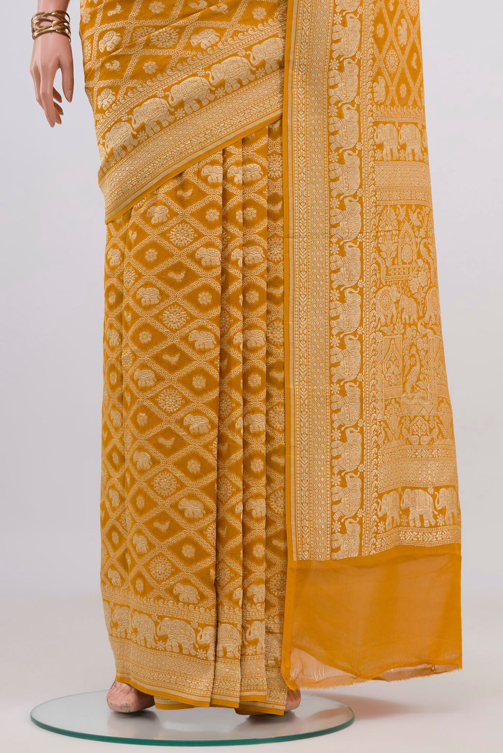 Pleats and pallu of Yellow Banarasi Georgette Saree with Zari Brocade on the body and Zari Border. 