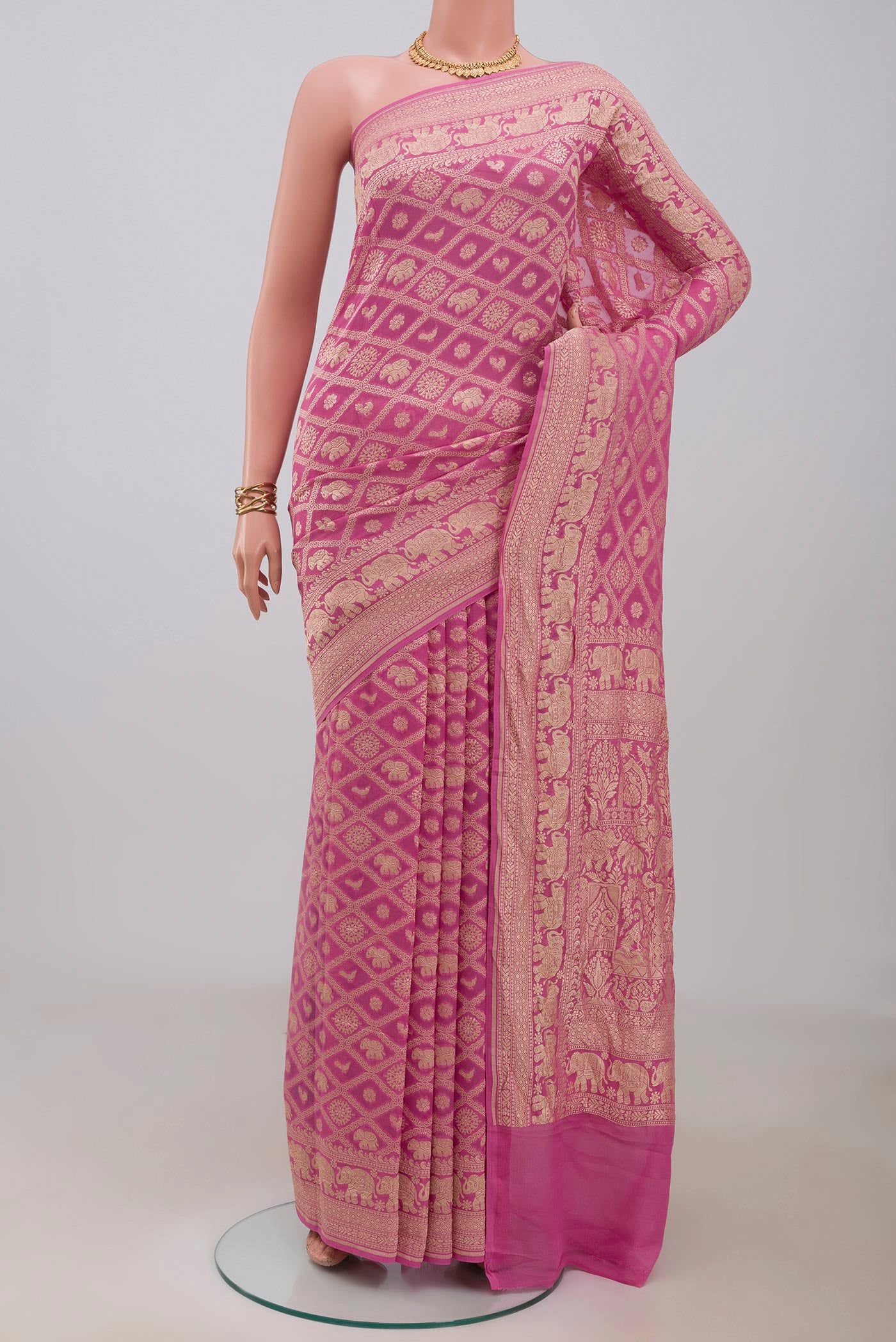 Pink Banarasi Georgette Saree with Zari Brocade on the body and Zari Border.  displayed on a mannequin