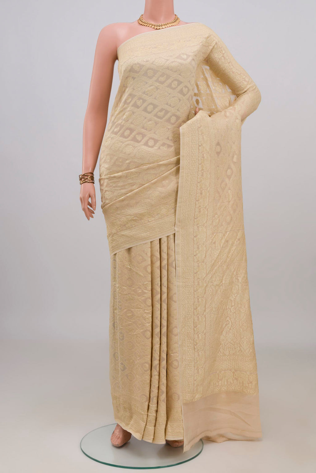Cream Banarasi Georgette Saree with Zari Brocade on the body and Zari Border.  displayed on a mannequin