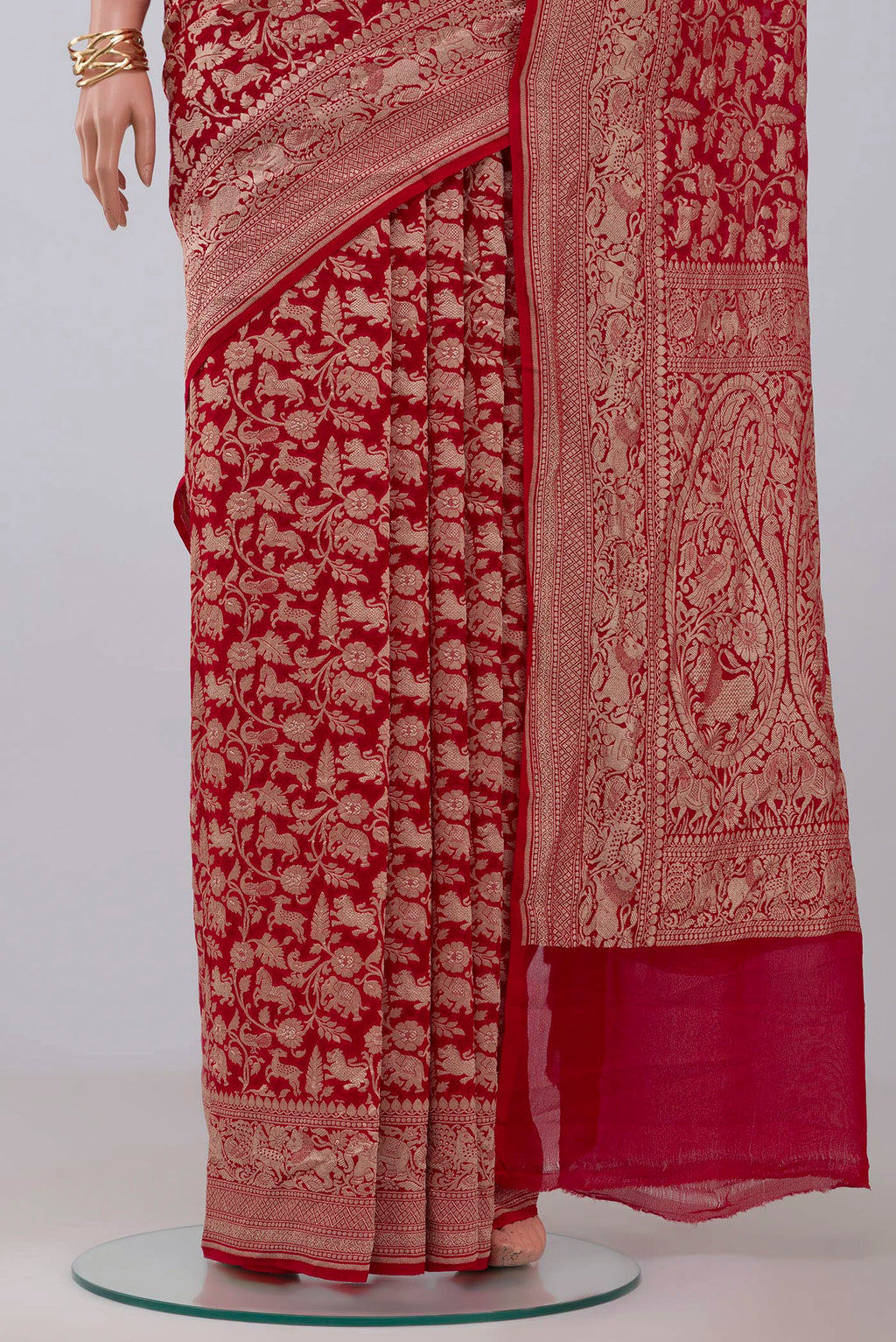 Pleats and pallu of Red Banarasi Georgette Saree with Fancy on the body and Zari Border. 