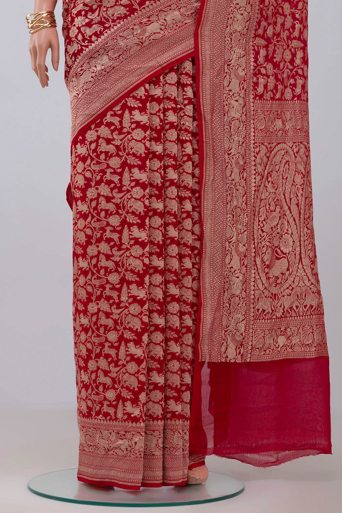 Pleats and pallu of Red Banarasi Georgette Saree with Fancy on the body and Zari Border. 