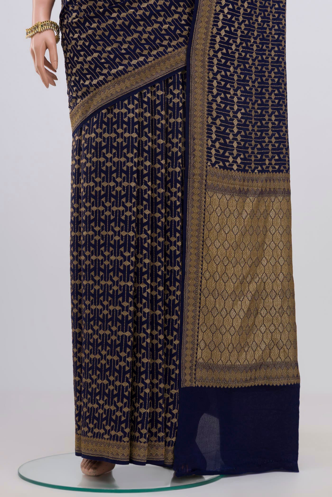 Pleats and pallu of Blue Georgette Saree with Fancy on the body and Zari Border. 