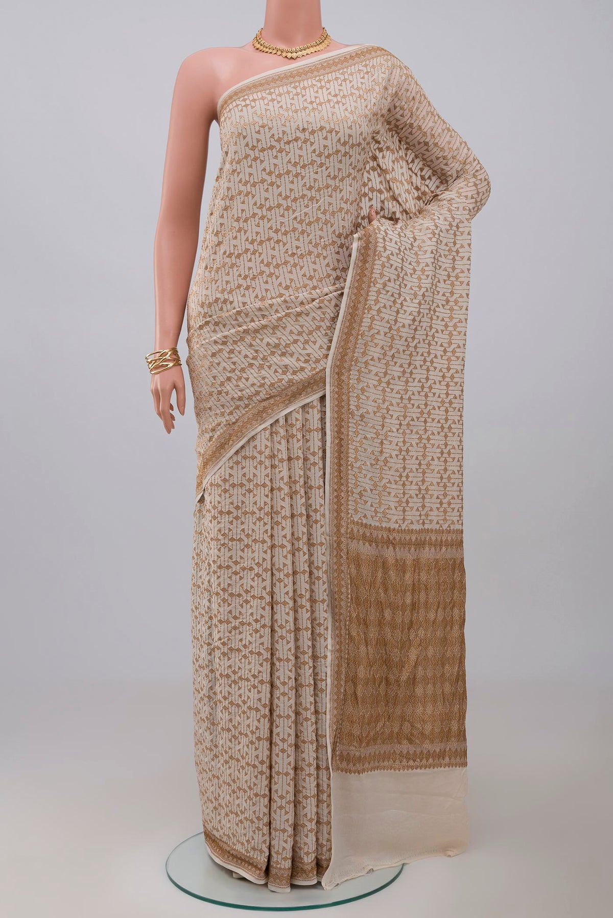 Cream Banarasi Georgette Saree with Fancy on the body and Zari Border.  displayed on a mannequin