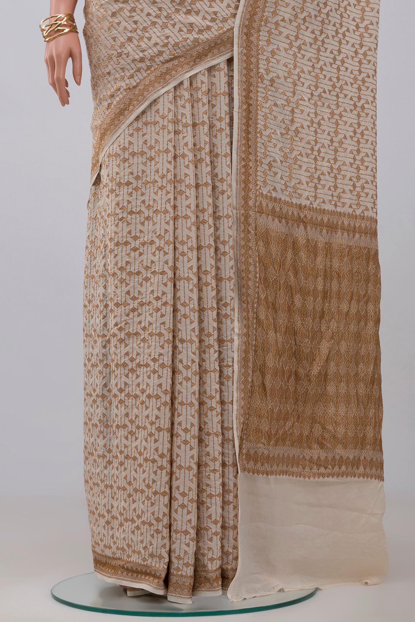 Pleats and pallu of Cream Banarasi Georgette Saree with Fancy on the body and Zari Border. 