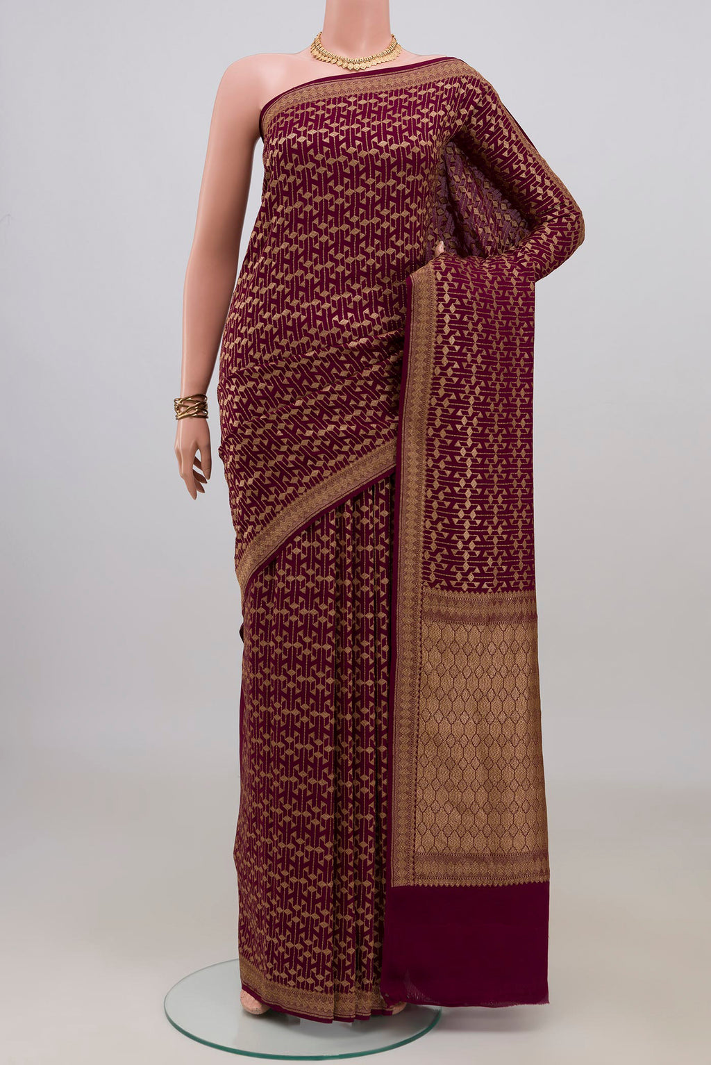 Maroon Banarasi Georgette Saree with Zari Brocade on the body and Zari Border.  displayed on a mannequin