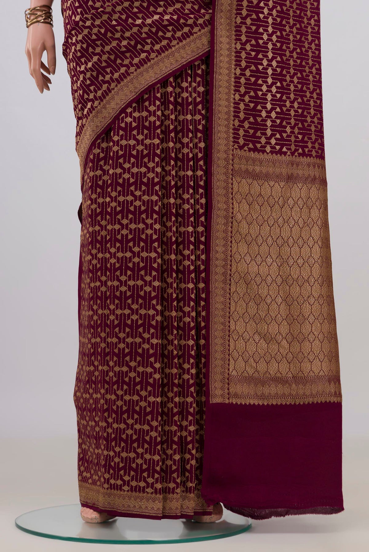 Pleats and pallu of Maroon Banarasi Georgette Saree with Zari Brocade on the body and Zari Border. 