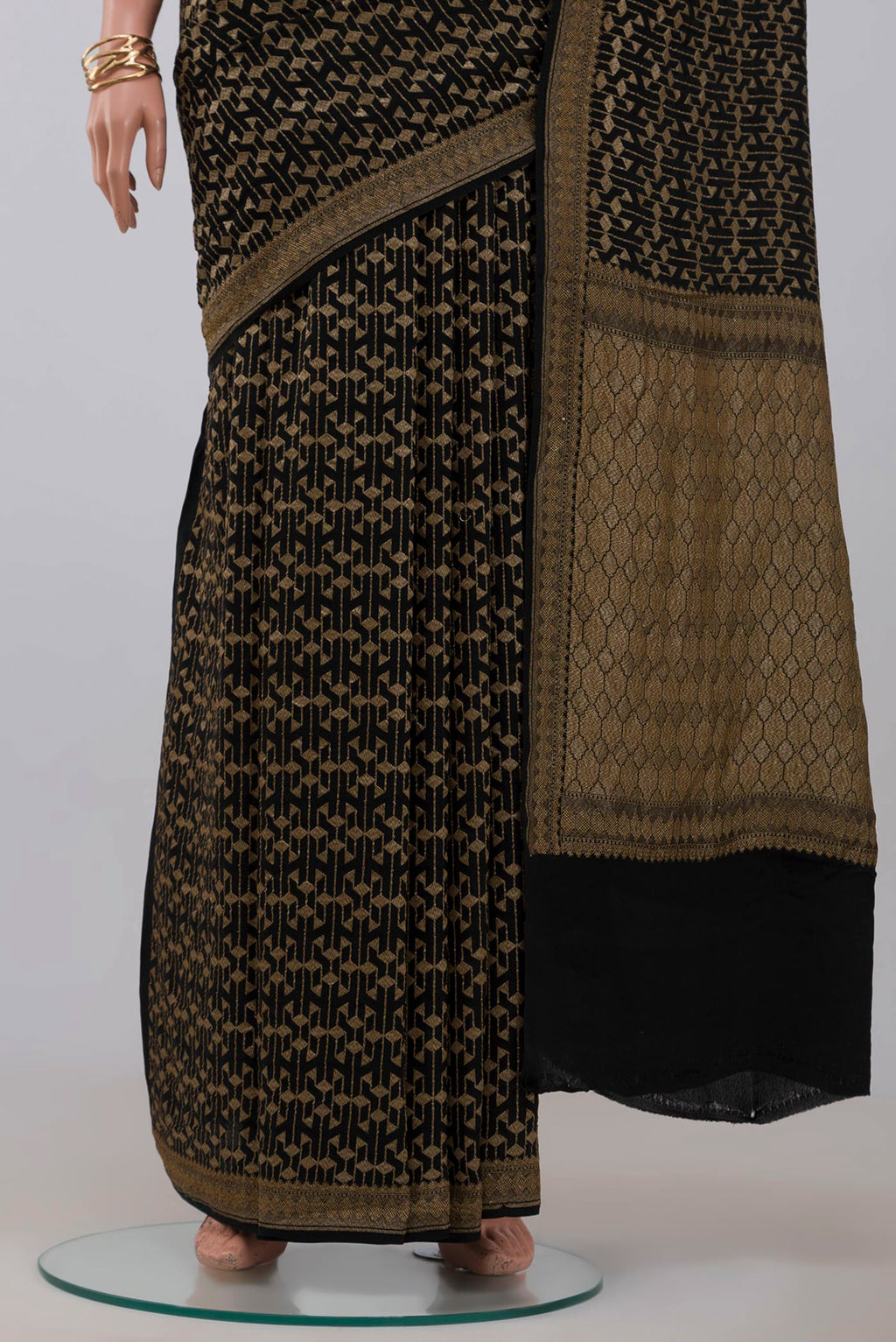 Pleats and pallu of Black Georgette Saree with Fancy on the body and Zari Border. 
