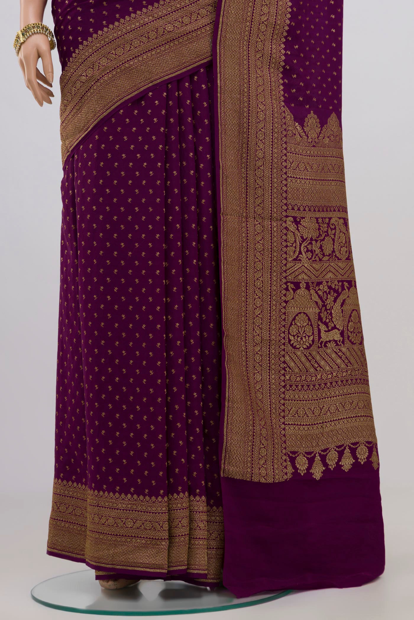 Pleats and pallu of Purple Georgette Saree with Fancy on the body and Zari Border. 