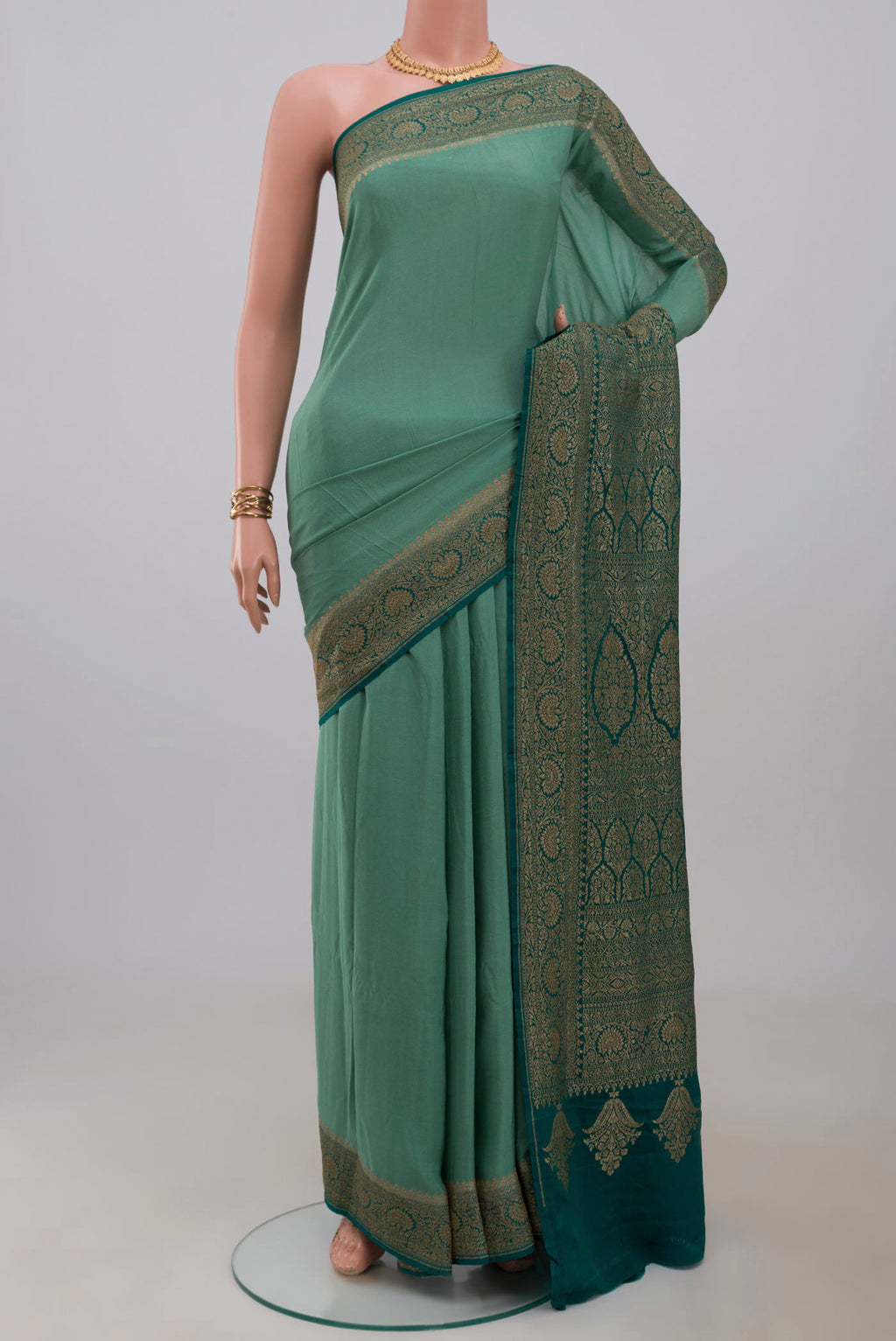 Sea Green Georgette Saree with Plain Body and Fancy Border.  displayed on a mannequin