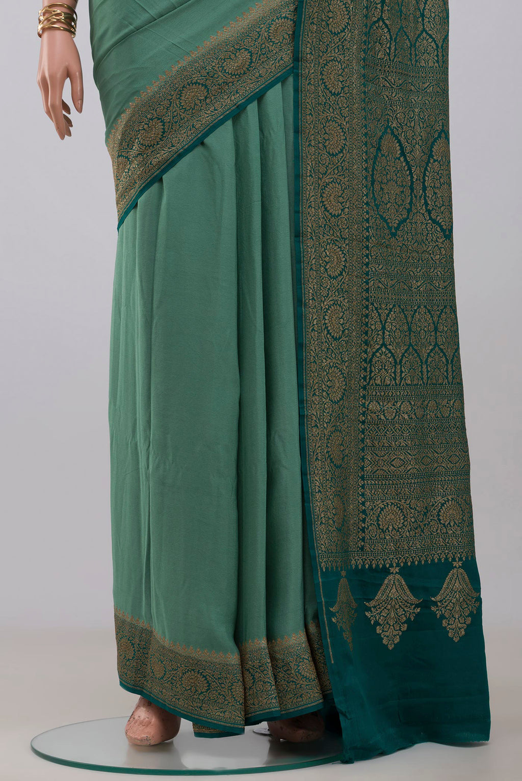 Pleats and pallu of Sea Green Georgette Saree with Plain Body and Fancy Border. 