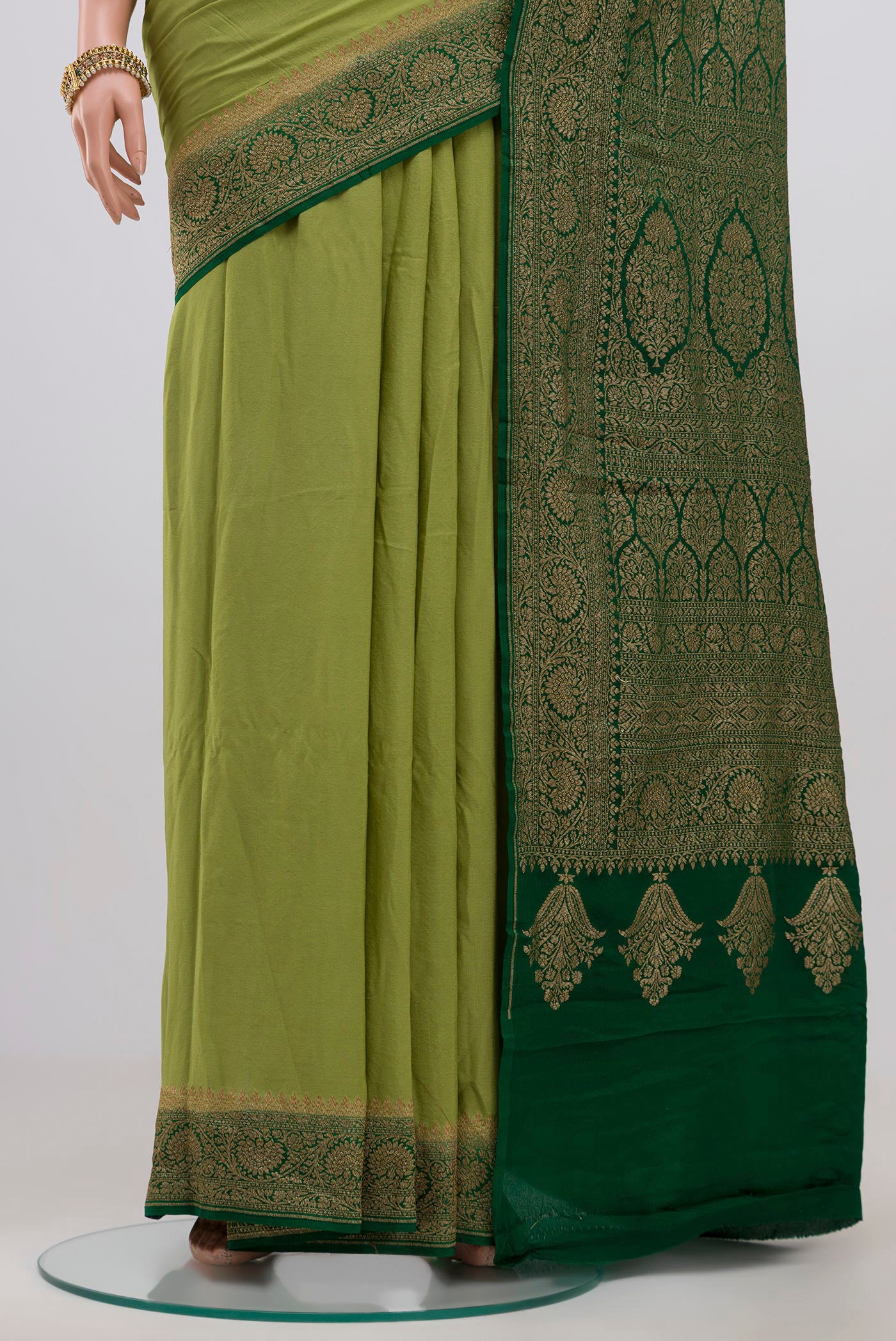 Pleats and pallu of Light Green Georgette Saree with Fancy on the body and Zari Border. 