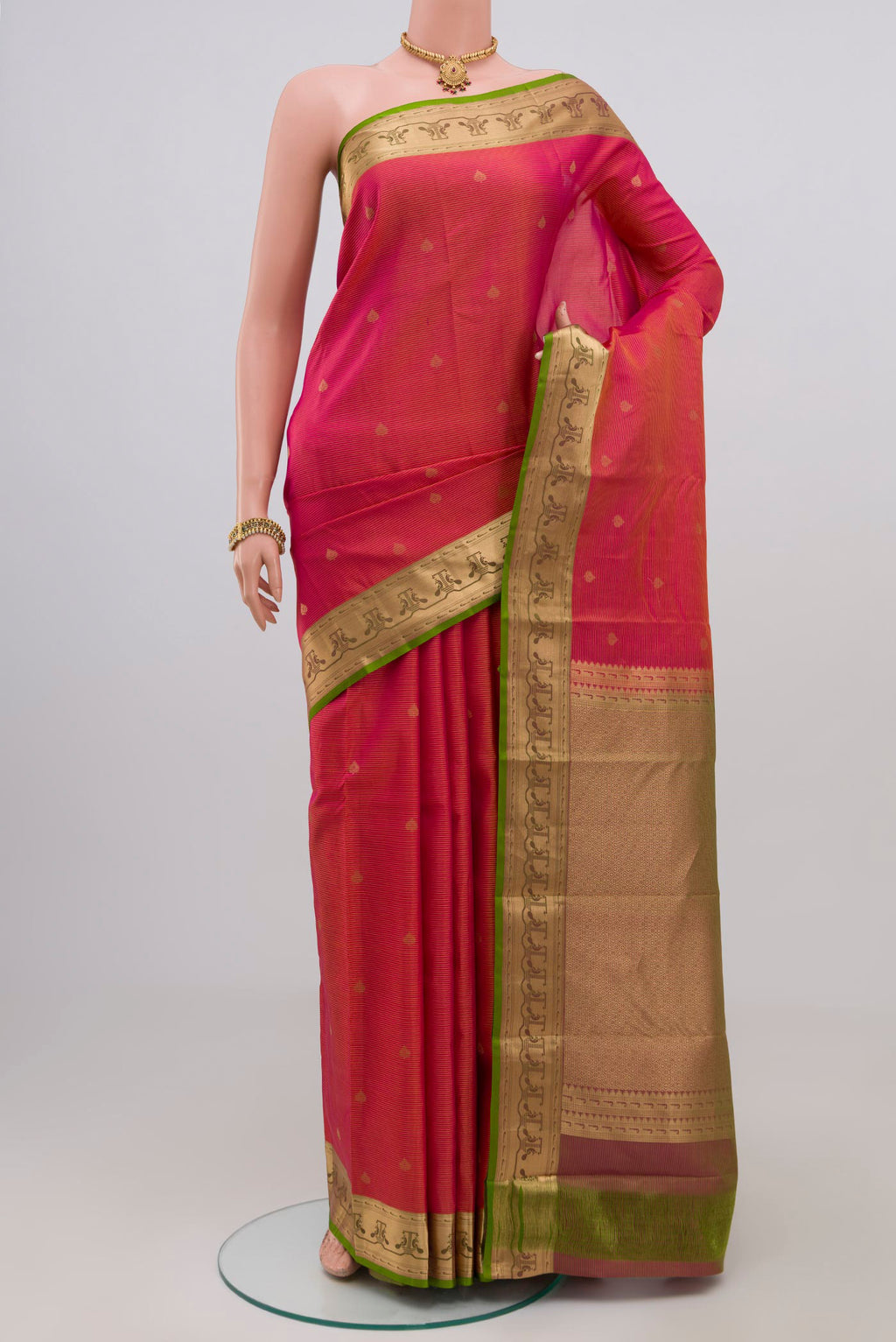 Pink Kanchipuram Silk Saree with Zari Butta on the body and Zari Border.  displayed on a mannequin