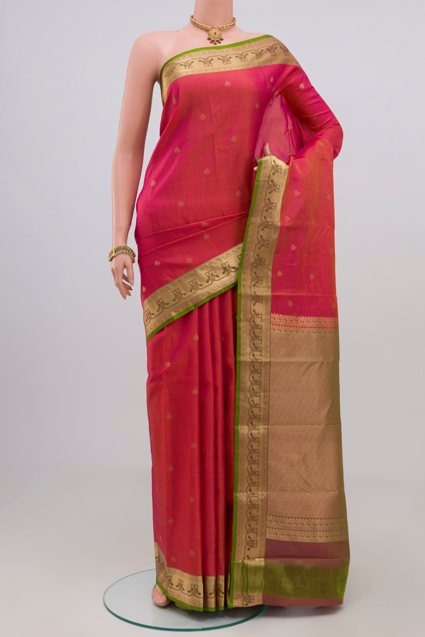 Pink Kanchipuram Silk Saree with Zari Butta on the body and Zari Border.  displayed on a mannequin