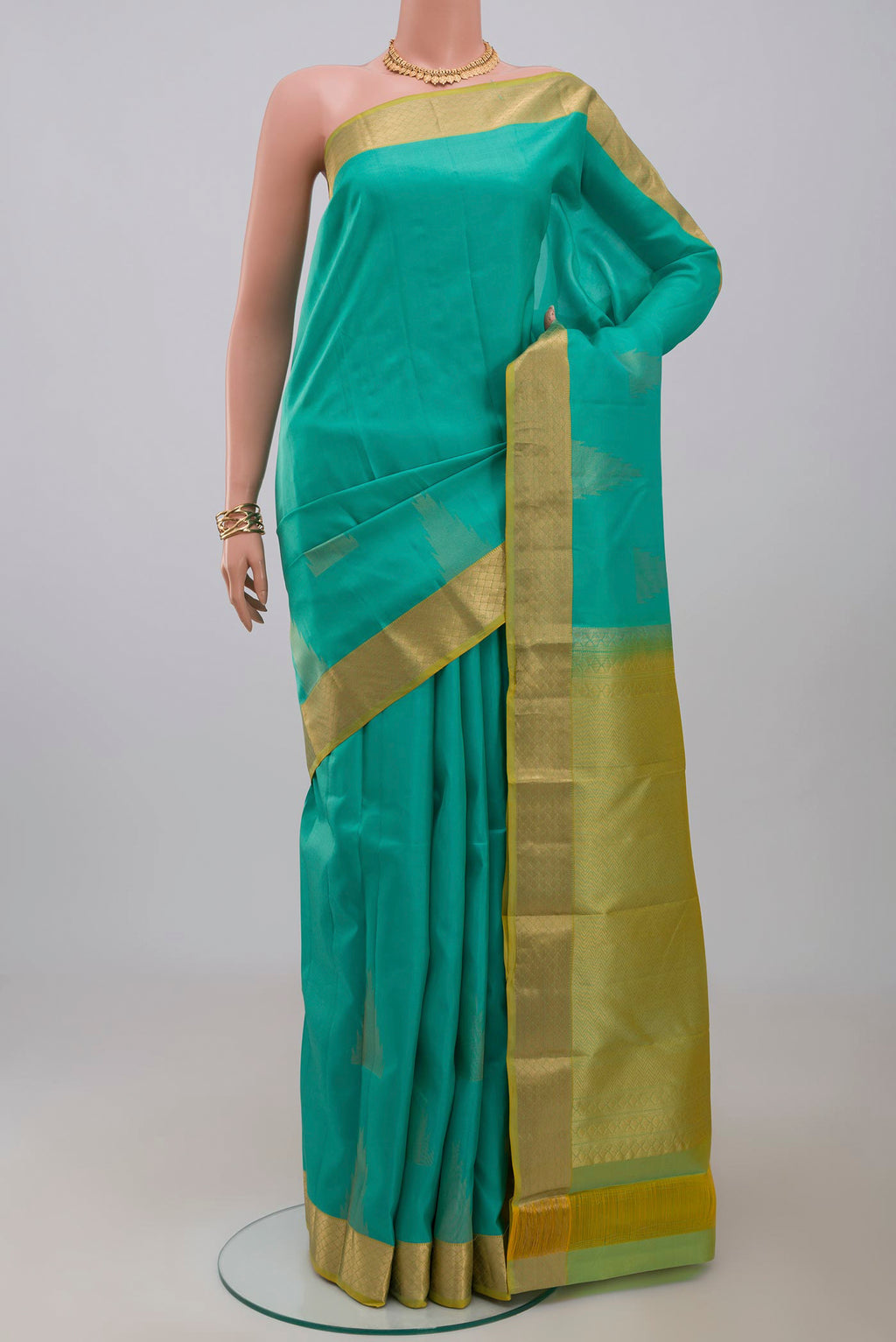 Blue Kanchipuram Silk Saree with Zari Butta on the body and Zari Border.  displayed on a mannequin