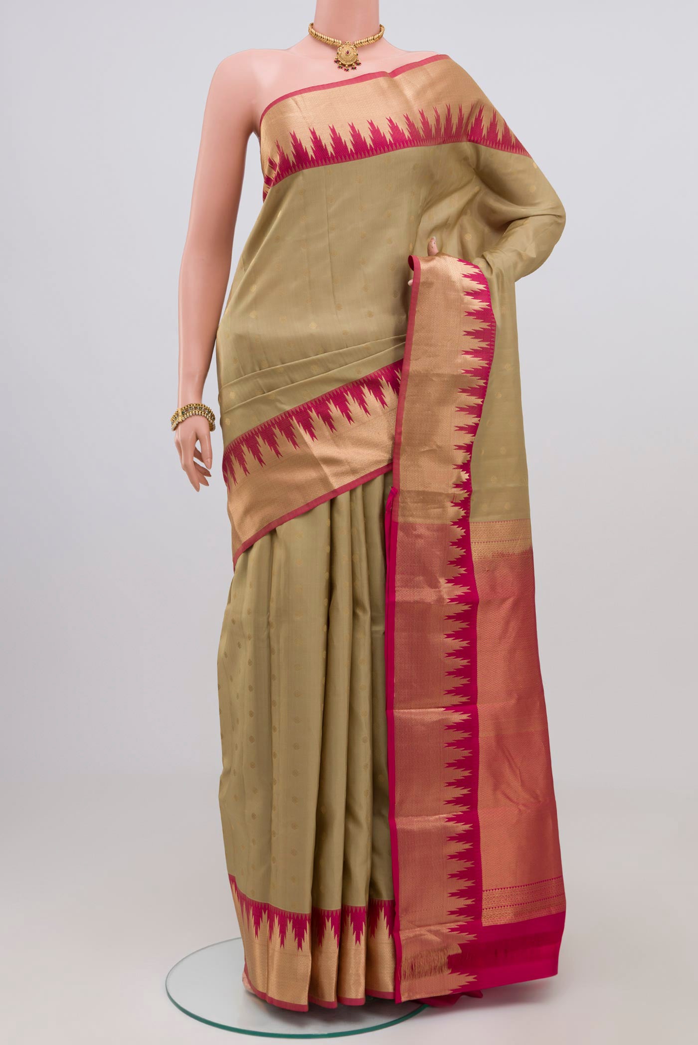 Cream Kanchipuram Silk Saree with Zari Butta on the body and Zari Border.  displayed on a mannequin
