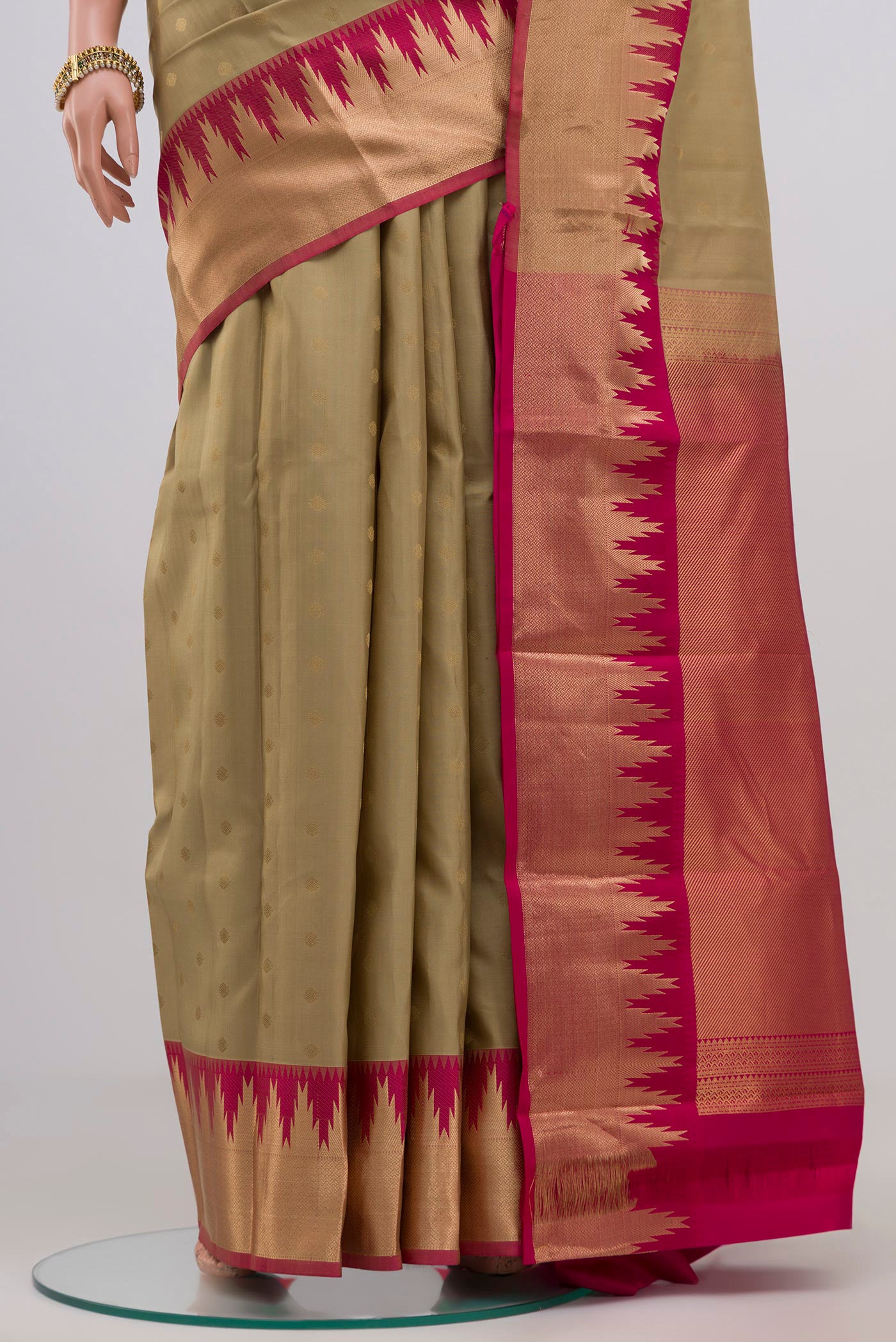 Pleats and pallu of Cream Kanchipuram Silk Saree with Zari Butta on the body and Zari Border. 