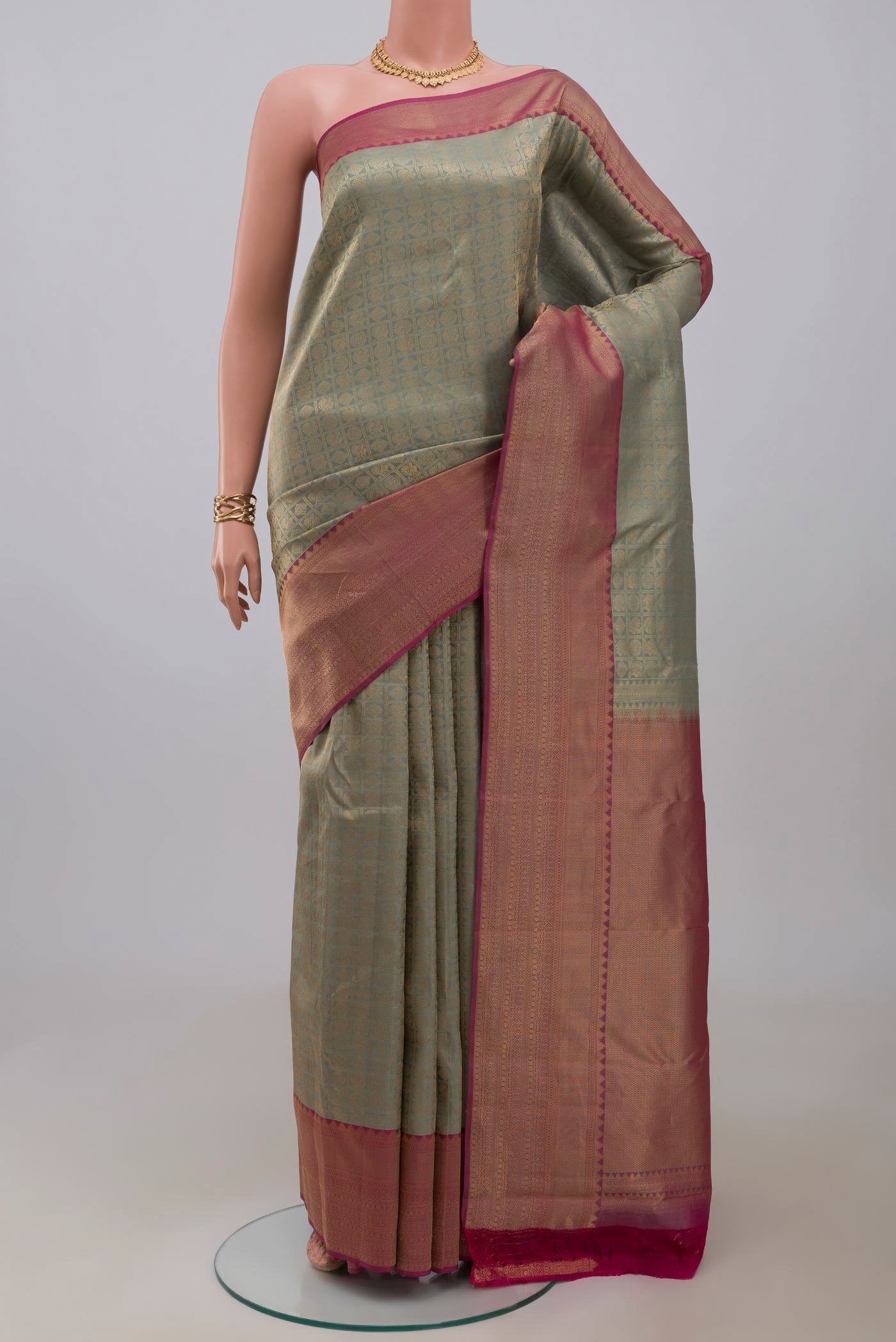 Sage Green Kanchipuram Silk Saree with Zari Brocade on the body and Zari Border.  displayed on a mannequin