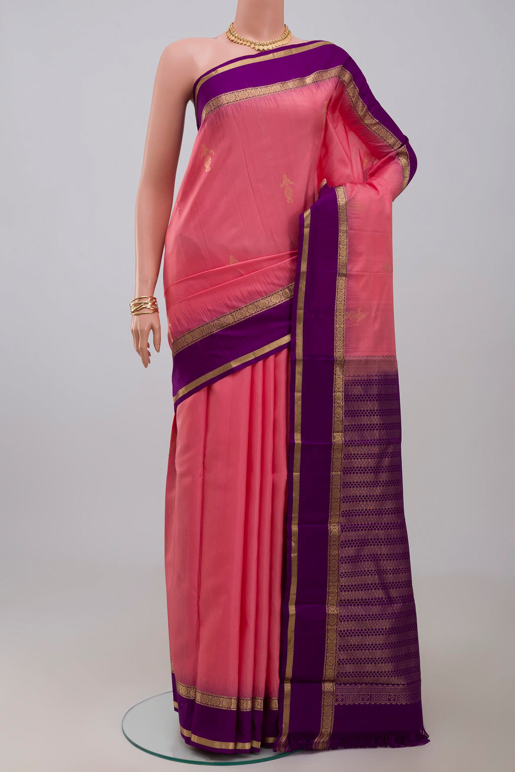 Pink Kanchipuram Silk Saree with Zari Butta on the body and Zari Border.  displayed on a mannequin