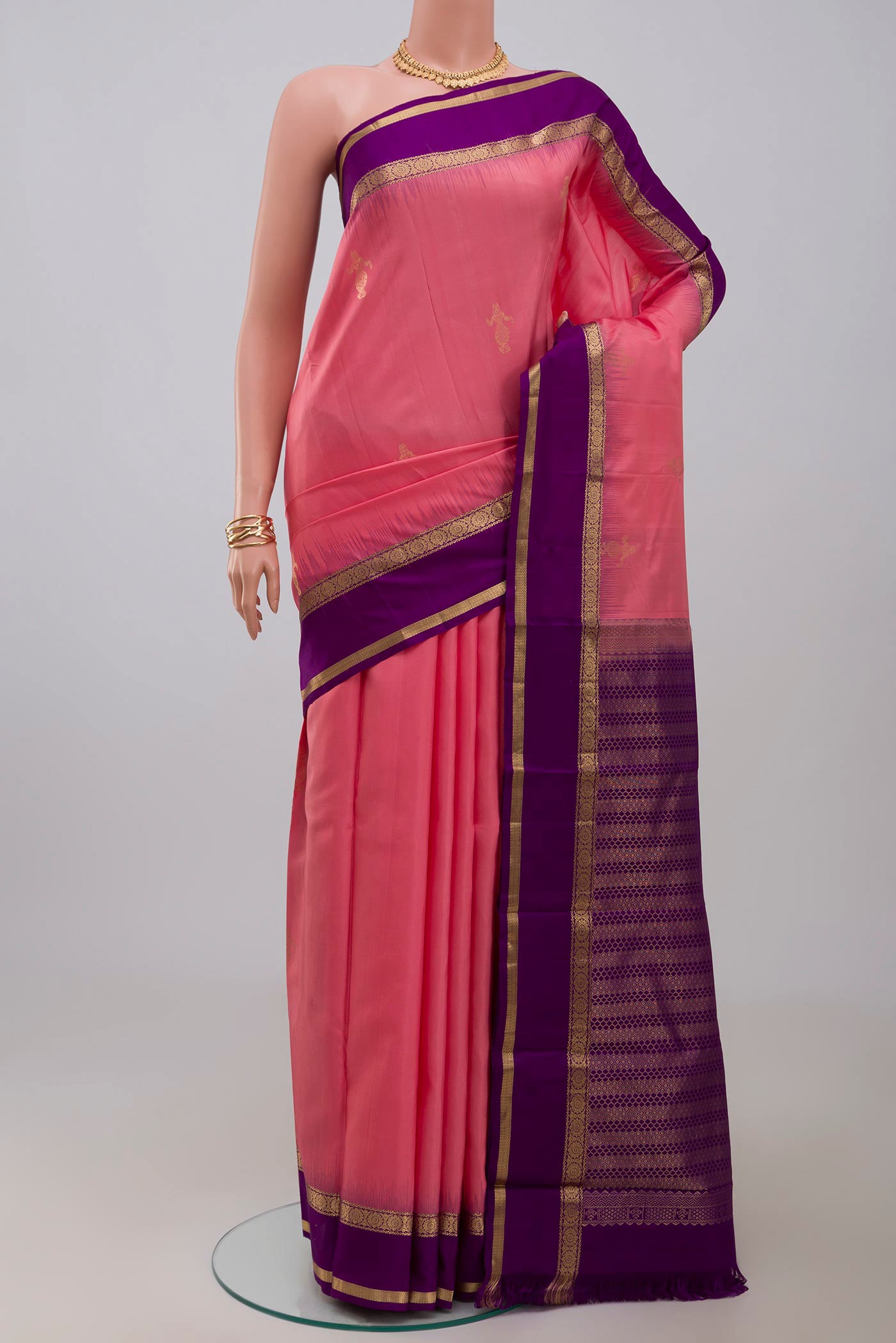 Pink Kanchipuram Silk Saree with Zari Butta on the body and Zari Border.  displayed on a mannequin