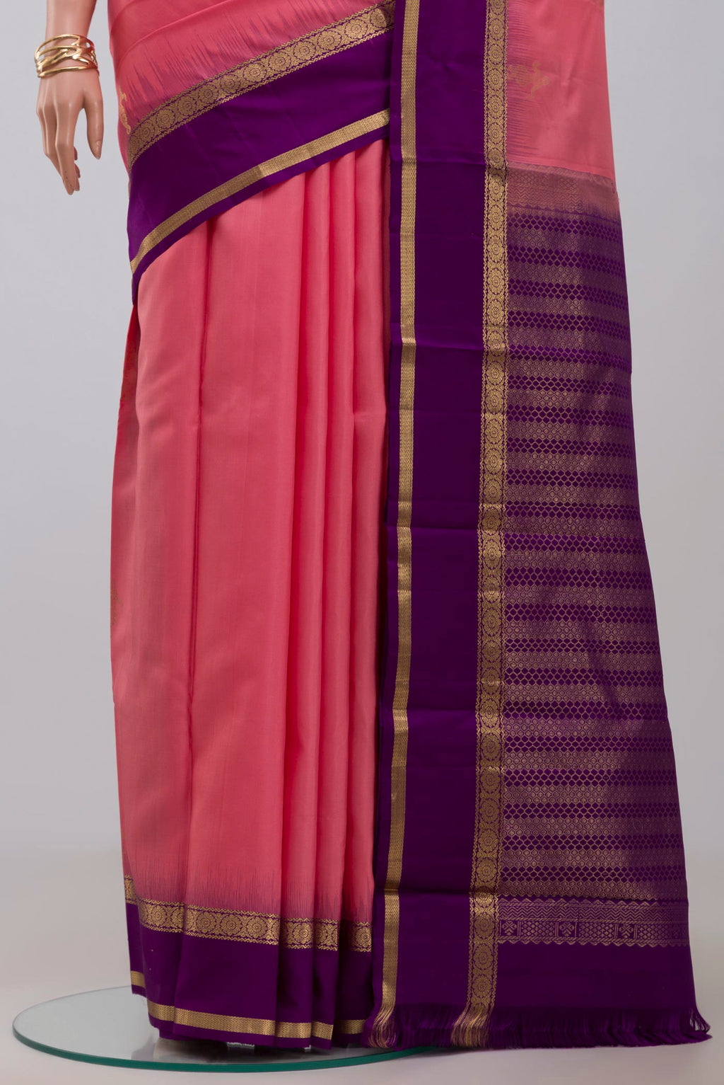 Pleats and pallu of Pink Kanchipuram Silk Saree with Zari Butta on the body and Zari Border. 