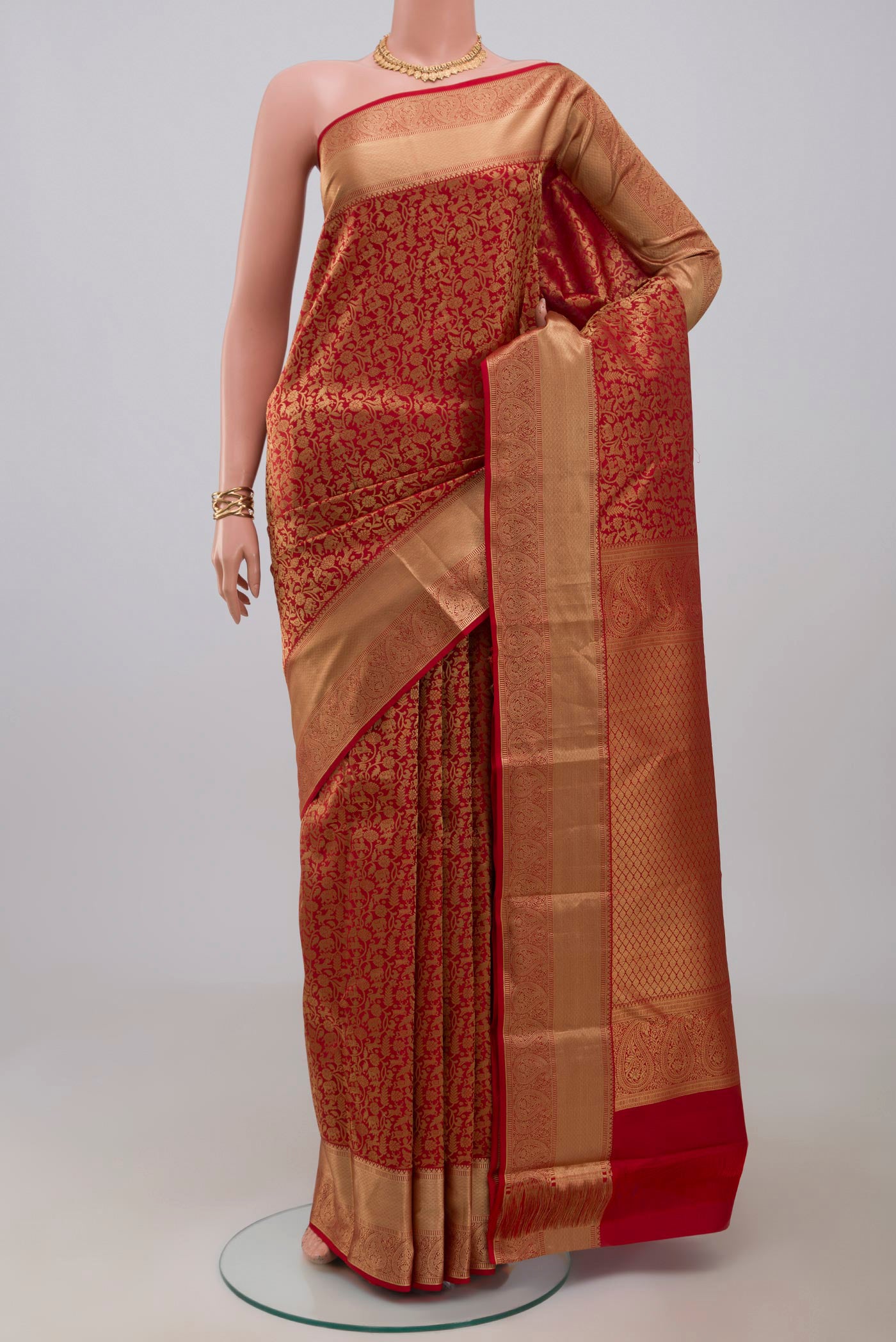 Red Kanjivaram Silk Saree with Zari Brocade on the body and Zari Border.  displayed on a mannequin