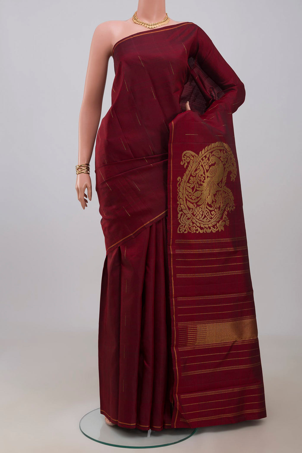 Maroon Kanjivaram Silk Saree with Fancy on the body and Thin Zari Line.  displayed on a mannequin