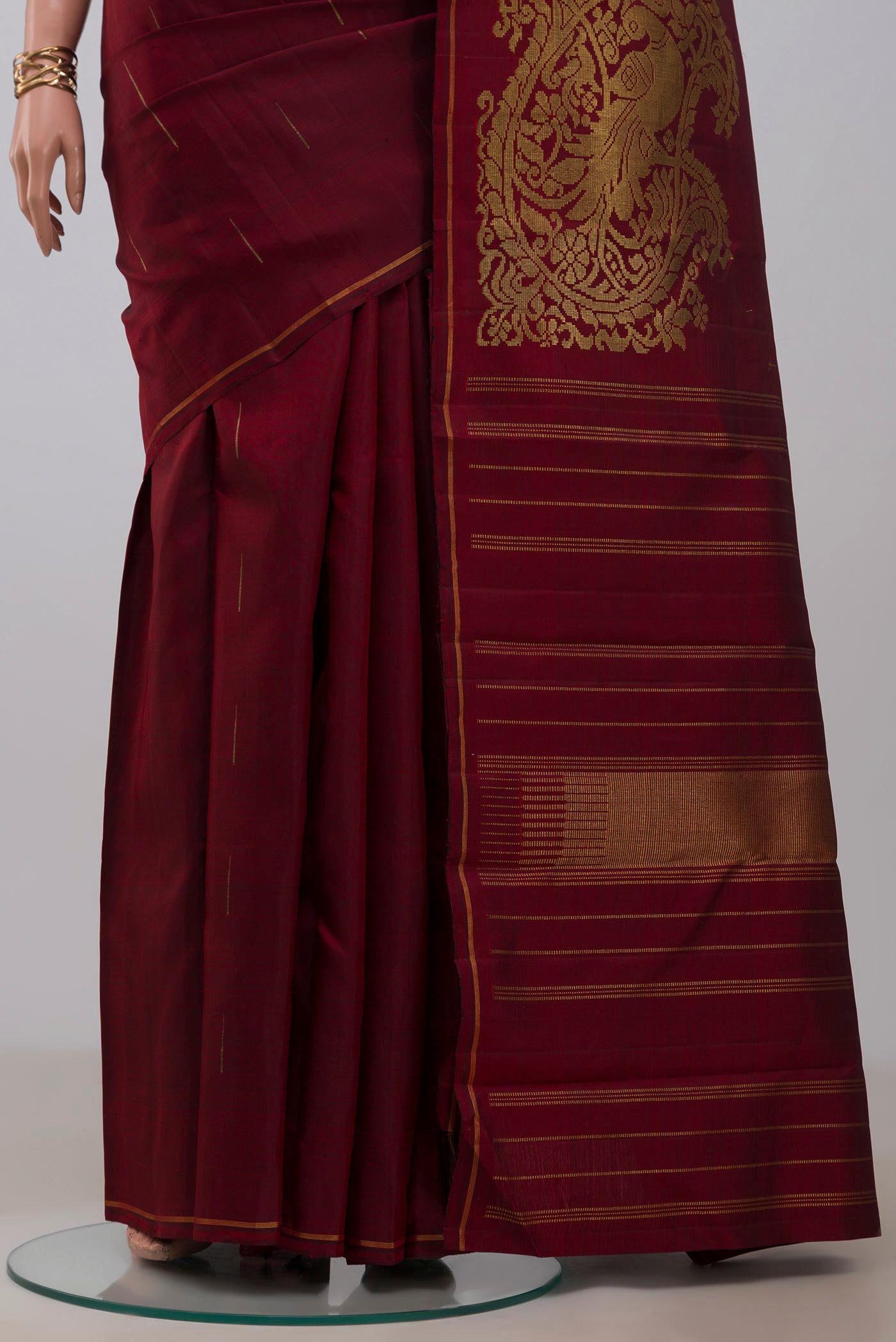 Pleats and pallu of Maroon Kanjivaram Silk Saree with Fancy on the body and Thin Zari Line. 