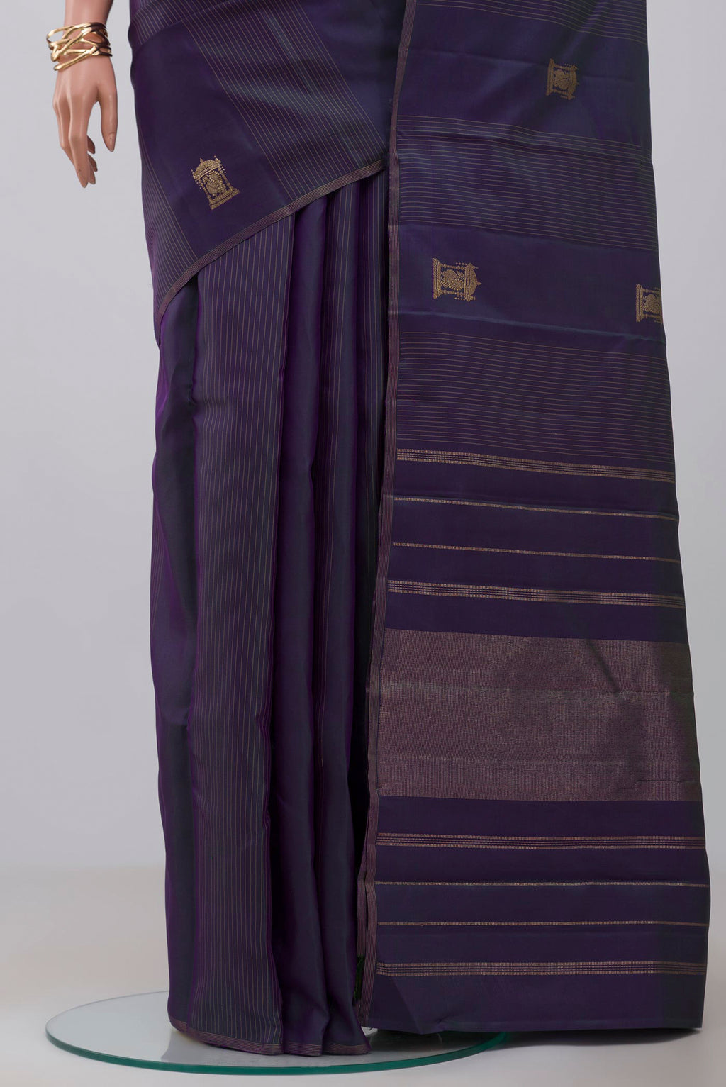 Pleats and pallu of Pure Silk Pure Zari Purple Kanjivaram Saree with Zari Butta on the body and Thin Zari Line. 