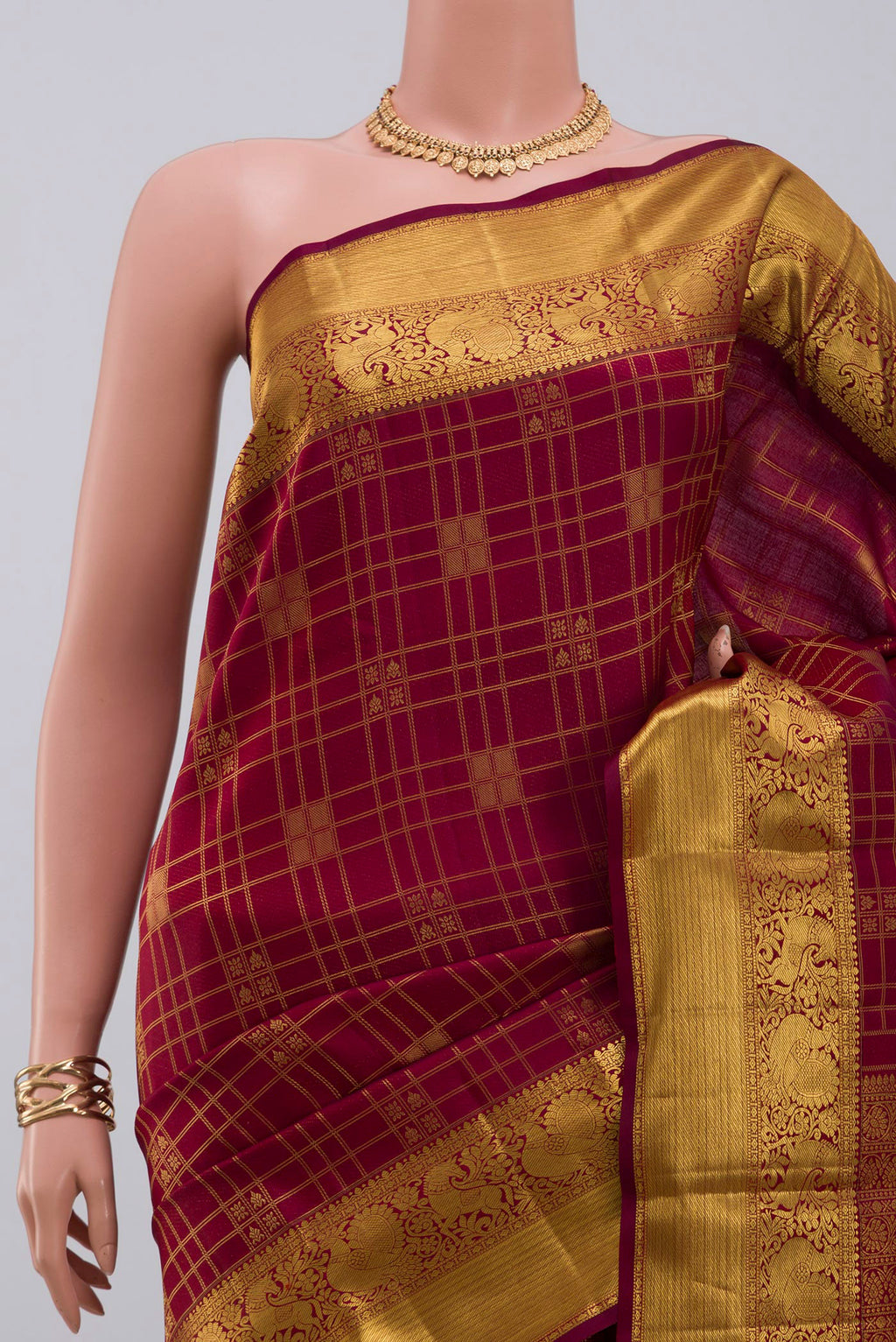 Border image of Maroon Kanchipuram Saree with Zari Brocade on the body and Zari Border. 