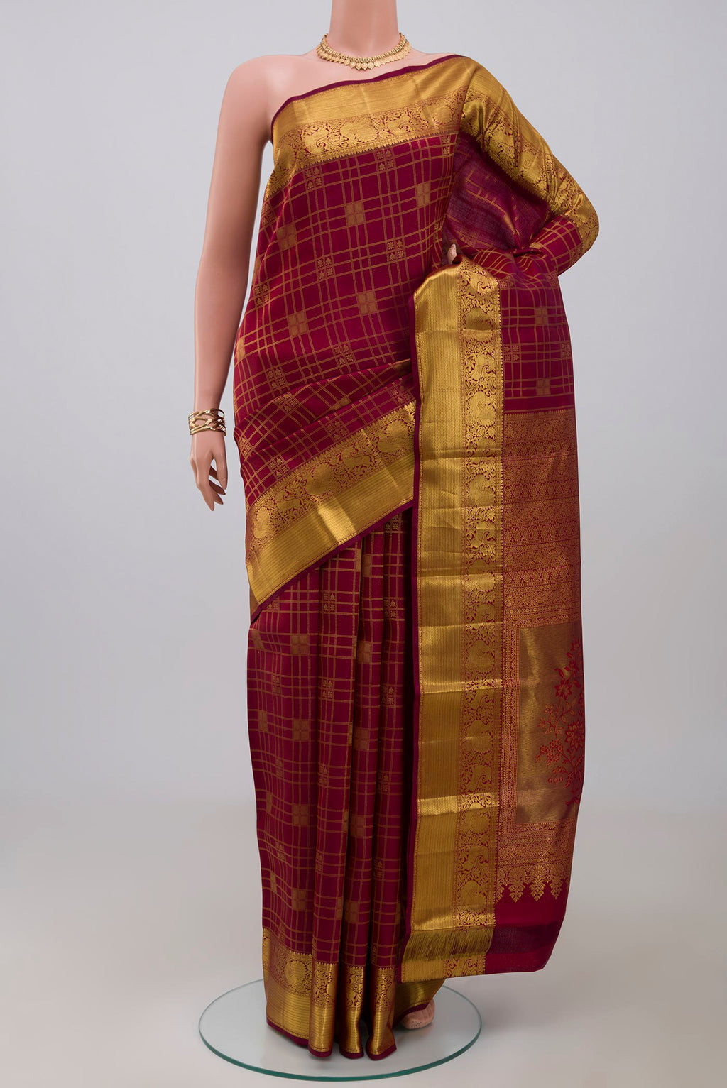 Maroon Kanchipuram Saree with Zari Brocade on the body and Zari Border.  displayed on a mannequin