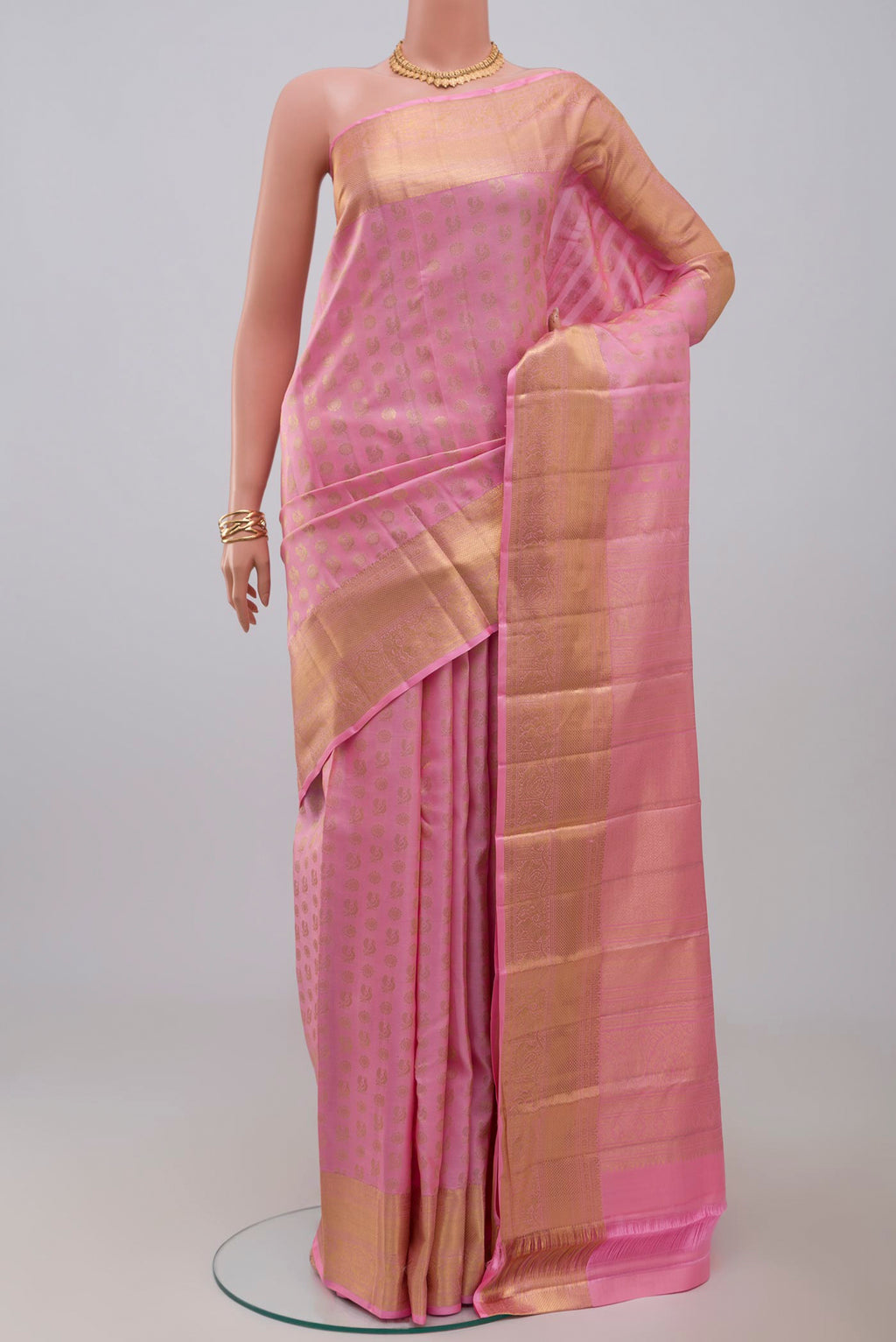 Pink Kanchipuram Silk Saree with Zari Butta on the body and Zari Border.  displayed on a mannequin
